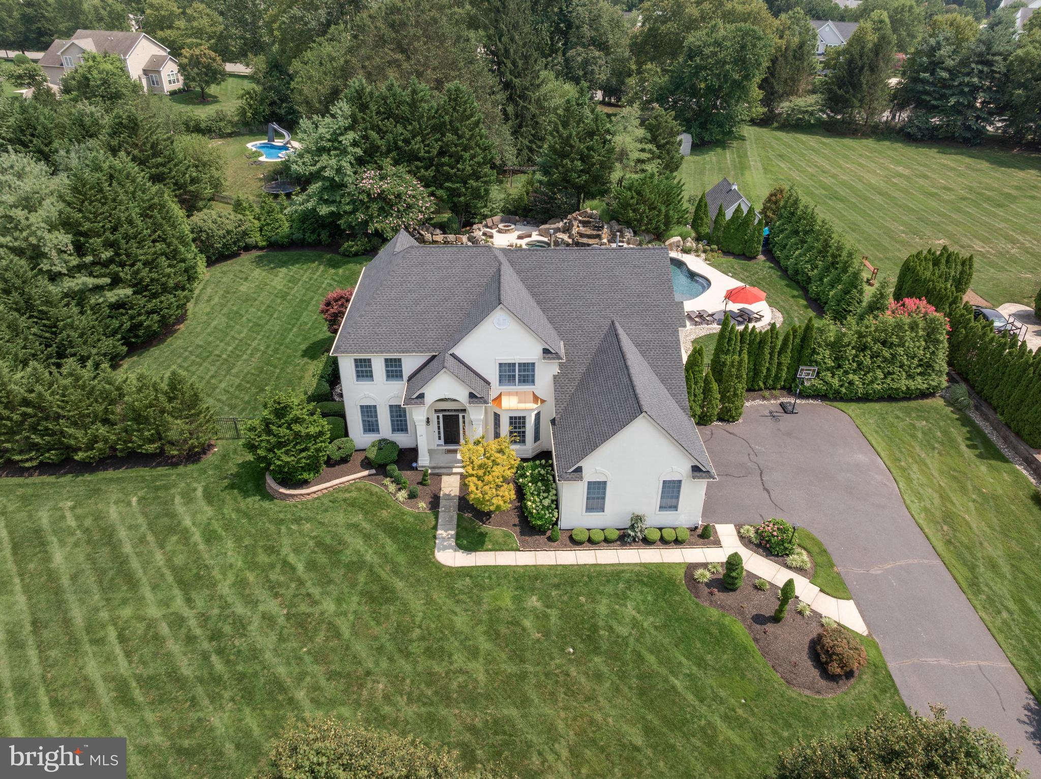 Prepare To Be Captivated By This Breathtaking 4 Bed, 3.5 Bath Luxury Estate, Perfectly Situated In One Of Lumberton’s Most Sought-After Neighborhoods. Poised On A Meticulously Manicured Homesite With Impressive Curb Appeal, This Custom Pond & Spitz Masterpiece In Coventry Glen Blends Timeless Elegance With Five-Star Resort-Style Living. Inside, Sophistication Abounds—From Rich Hardwood Floors And Exceptional Millwork To Expansive Living And Entertaining Spaces Designed For Both Comfort And Grandeur. The Heart Of The Home Is The Beautifully Renovated Designer Kitchen, Featuring High-End Finishes, Sleek Stainless Steel Appliances,  Quartz Counters, A 6x5 Center Island, Stylish Marble Backsplash, And Seamless Flow To The Formal And Casual Living Areas. The Main Floor Also Features A Private Office, Ideal For Working From Home, As Well As A  Mudroom/Laundry Room Just Off The 3 Car Garage...A Car Enthusiast's Dream With Epoxy Covered Flooring And Honeycomb Style LED Lighting.  Step Outside And Be Transported To Your Own Private Paradise. The Crown Jewel Of The Property Is The Extraordinary Backyard Oasis: A Heated, Custom Gunite Pool Wrapped In Travertine And Enhanced With Stone Hand-Harvested From The Princeton Quarry. This One Of A Kind Salt Water Pool Features A New (2025) Heater, Dramatic 15-Foot Cascading Waterfall, A Hidden Grotto, Dual Sun Shelves, And A Thrilling 30-Foot Dolphin Slide Seamlessly Carved Into The Rock Wall—This Is Outdoor Living At Its Finest. The Covered Pavilion-Style Lounge Is Built For Year-Round Entertaining, Complete With A Full Outdoor Kitchen, Smoker, Built-In Grill, Beverage Center, Stone Fireplace With Mounted TV, Ceiling Heaters, And Plenty Of Seating—All Just Steps From The Main Kitchen. Tranquility Continues Throughout The Grounds With A Serene Koi Pond, Professional Landscaping, Outdoor Lighting, And Extensive Hardscaping. As If That Weren’t Enough, A Temperature-Controlled Shed Houses A State-Of-The-Art Golf Simulator, Offering A Personal Driving Range No Matter The Season. The Home Is Wired With A Premium Sonos Sound System Extending Through The Kitchen, Family Room, Basement, And Backyard. Back Inside And Upstairs, The Sumptuous Primary Suite Offers A Private Retreat, Complete With An Ensuite Bath, While The Additional Princess Suite Provides A Luxurious Space For Guests Or Loved Ones.  Two Other Generously Sized Bedrooms Are Serviced By A Full Hall Bath. A Fully Finished Basement Featuring An LED Light Tray Ceiling Adds Another Dimension Of Living—Ideal For Theater Style Movie Nights As Well As Fitness In  A Dedicated Mirrored Home Gym.  All Of This And So Much More In An Ideal Location Close To Schools, Shopping, Dining, And Major Roads. Signature Properties Of This Caliber Rarely Come To Market. Indulge In The Lifestyle You Deserve. Your Dream Escape Awaits—Right At Home.