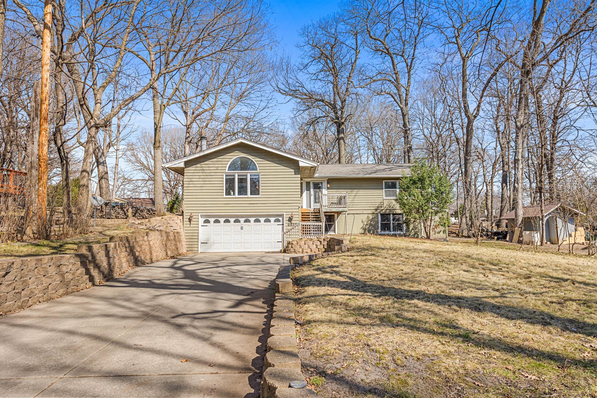 Seller is offering a 10k allowance for cosmetic upgrades with an acceptable offer!!This home offers the perfect opportunity to move right in while adding your own updates and personal touches over time. Ideally located in the sought-after Carver Beach neighborhood, it's just a short two-block walk to two access points at Lotus Lake, including Carver Beach and within the highly regarded Minnetonka School District. Many major improvements have already been completed, including a new roof (2020), furnace and A/C (2021), water softener (2026), and dishwasher (2025), allowing you to focus on the finishing details. The main level is sure to impress, featuring a spacious vaulted living room with a charming wood-burning fireplace, beautiful oak hardwood floors, and an inviting layout. The dining room walks out to a cozy deck and fire pit, while the kitchen offers stone countertops and access to a private patio. Two bedrooms are located on the main level, including a primary suite with a three-quarter bath and walk-in closet. The lower level provides additional space with a large family room, an extra bedroom with an oversized walk-in closet, a finished laundry room, full bath, flex room, and walkout access to the tuck-under garage. A home with incredible potential in a prime location - don't miss this rare opportunity to move right in and build equity!
