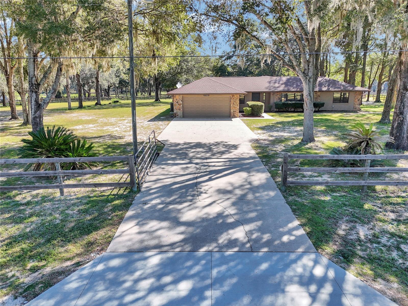 4-Acre A-3 Horse-Ready Estate | Renovated Pool Home | Near WEC & Riding TrailsRare opportunity to own 4 acres of A-3 agricultural property in Rolling Hills of Ocala with a renovated 3-bedroom, 2-bath pool home, fenced pasture, 1-stall barn, multiple garages, and room for horses, trailers, animals, and equipment.The pasture features 3-board and no-climb fencing, a gated entry, and ample turnout space. The Greenway and riding trails are approximately 2 miles away, and the World Equestrian Center is a short drive.The 2026 renovation includes new LVP flooring, granite countertops, updated kitchen and bathroom cabinetry, renovated bathrooms, new fixtures and hardware, fresh paint, a new stove, and a freshly painted pool deck and patio. Additional updates 2018 HVAC, 2025 water heater, and 2026 pool pump. Enjoy the screened-in-ground pool and spacious outdoor areas. The property also includes a 2-car attached garage, detached 1-car garage/workshop, and adjacent concrete pad with flexible space for equipment, a wash rack, kennel, or other use. An approximately 600-square-foot screened area under the main roof provides additional covered outdoor space and potential for future enclosed living area. Private well and septic. No flood zone. Conveniently located near WEC, Rainbow River, Greenway riding trails, and Hwy 200 shopping and amenities. Bring your horses, trailers, toys, and plans. This is acreage with a purpose—and a move-in-ready home to enjoy it from.