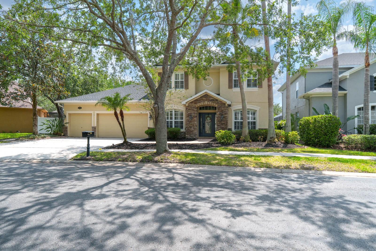 Under contract-accepting backup offers. Nestled in the exclusive gated enclave of Buckingham at Tampa Palms, this stunning Southern-style pool home blends timeless elegance with contemporary upgrades—offering the ideal Florida lifestyle in one of Tampa’s most coveted communities!! From the moment you arrive, the exquisite curb appeal captivates with stone accents, a pavered front walkway, upgraded landscape lighting, a charming side stone path and a new roof (2023). Step inside to discover a beautifully maintained interior, featuring rich hardwood floors, 5 ¼" baseboards, deep crown molding, and elegant plantation shutters throughout. The spacious layout includes a luxurious first-floor owner’s retreat with custom closet, while the second level offers three generously sized bedrooms and an impressive bonus room —perfect for a home theater, game room, or additional office. The fully remodeled staircase showcases iron balusters, fluted newel posts, and hardwood treads, elevating the home's architectural character. Designed with the chef in mind, the kitchen is a true showstopper—featuring top-of-the-line stainless-steel appliances, a new dishwasher, a new gas range and electric convection oven, Sub-Zero refrigerator, 42" raised-panel maple cabinetry, granite island workstation, Cambria quartz countertops, GE convection microwave, and a spacious walk-in pantry. Upstairs you’ll find abundant storage, along with beautifully updated secondary baths adorned with designer cabinetry, granite countertops, and stylish fixtures. Step outside to your own private retreat—a serene lanai with a European spa feel, pavered deck and a sparkling saltwater pool with a variable speed pump and recent resurfacing. The fenced backyard offers privacy and space for entertaining or relaxation. Additional upgrades include recent designer paint, diagonal-laid tile flooring, new carpet (2022),  updated lighting and ceiling fans, solar attic fan, custom wall moldings, wireless features, gutters, and more. Ideally located just minutes from top-rated schools, USF, Moffitt, VA and Advent Health hospitals, USAA, I-75 and I-275, this exceptional home offers both luxury and convenience with easy access to all the shopping, dining, and entertainment that Tampa Bay has to offer. Don’t miss your chance to own this meticulously upgraded home in the heart of Tampa Palms—schedule your private showing today!