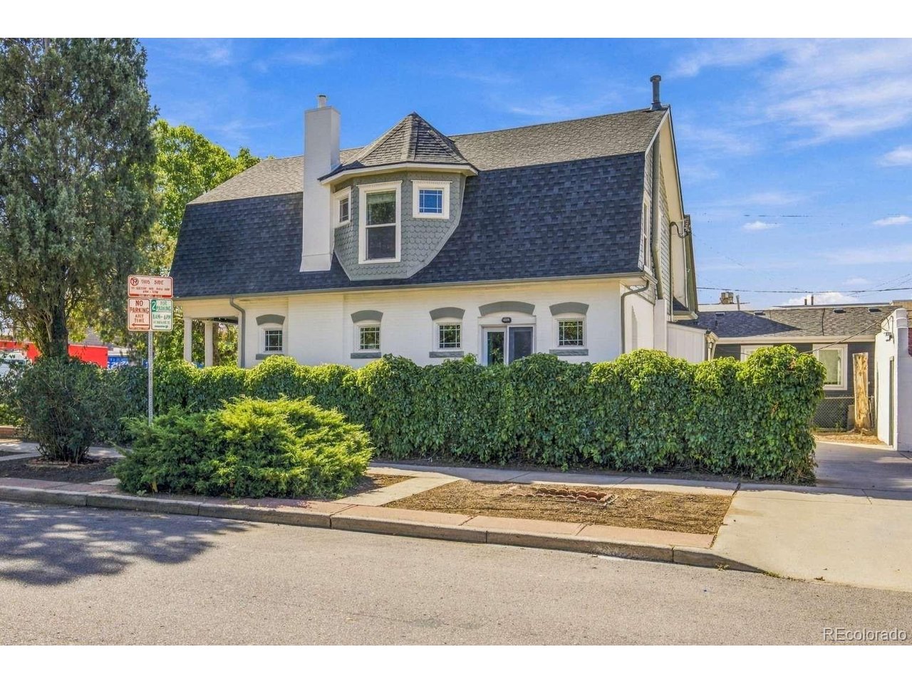 Dutch Colonial gem in Lincoln Park. Steps from the Santa Fe Art District and 6 blocks from the planned Denver Broncos' stadium Village Center. Get in ahead of this redevelopment. Minutes to downtown, next to I-25/6th Ave interchange, and a short walk to 10th&Osage light rail. Hardwood floors throughout. Main level offers a bright living room with a gas fireplace flowing into the dining area, French doors to a side deck, a kitchen with granite counters, stainless appliances, and pantry cabinets, plus a half bath. Upstairs, the primary suite features a turret-windowed sitting room/office, walk-in closet, and double-vanity bath, joined by two bedrooms and a 3/4 bath. Half-finished basement with laundry and storage. Outside, gated front and driveway entrances, large driveway, and 1-car garage. C-MX-3 mixed-use zoning allows residential and commercial use. Proven track record as licensed owner-occupied short-term rental with strong demand in this walkable, central location. Well cared for, with updates including a new sewer line, furnace and central air, tuckpointing on the house and garage, refinished porch, updated walkway and driveway pad, and fresh interior and exterior paint.