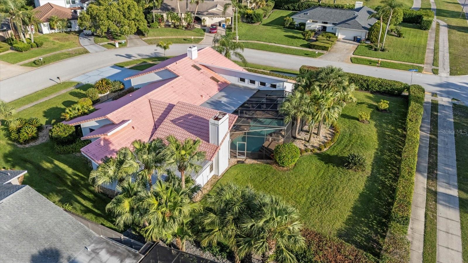 One or more photo(s) has been virtually staged. Do not miss your opportunit to BUILD INSTANT EQUITY in Clearwater’s Coveted “Landmark” Neighborhood. Price improvement places this home significantly less than similarly renovated homes selling for over $1,000,000! No HOA fees • 5 Bedrooms + Office + Bonus Room • Resort-Style Pool!
Opportunity is knocking in one of Clearwater’s most sought-after neighborhoods! This stunning 5-bedroom, 2.5-bath home with an office and bonus room sits proudly on a prime corner lot in the prestigious Landmark section — and it’s priced well below remodeled comparables. The home is beautiful as-is.  You can move right in and enjoy the gorgeous renovations already completed, while taking your time to plan the next updates that will truly make this home your own.

From the moment you arrive, custom solid wood double doors set the tone for the home’s timeless character. Inside, you’ll find a beautifully designed open layout perfect for modern living and entertaining, featuring a dramatic stone fireplacein the great room, soaring shiplap ceilings, and full pocket sliding doors that open seamlessly to your screened-in saltwater pool and lanai — your private outdoor retreat.

The spacious kitchen offers granite countertops, walk-in pantry with secondary refrigerator, and wraparound bar seating for six. A convenient pass-through window to the lanai makes entertaining effortless.
Need flexibility? The dedicated office opens wide to the pool through hurricane-rated accordion doors, and the 400+ sq. ft. bonus room is your blank canvas — perfect for a home gym, art studio, media room, yoga retreat, or future in-law suite with separate entry.

The primary suite is a private sanctuary featuring wood-beamed vaulted ceilings, a cozy stone fireplace, pool access, and a spa-style ensuite bath with dual vanities, makeup station, and hidden jacuzzi tub.

Outdoors, unwind under glowing Florida sunsets by your screened saltwater pool, surrounded by tropical privacy and space to entertain in style.

Recent updates already completed include: Redesigned open-concept layout, Luxury vinyl plank flooring, Shiplap ceilings, saltwater pool system

This home isn’t just a place to live — it’s your opportunity to create a million-dollar showpiece in one of Clearwater’s most desirable neighborhoods.

Act fast — homes with this size, location, and equity potential rarely come along.