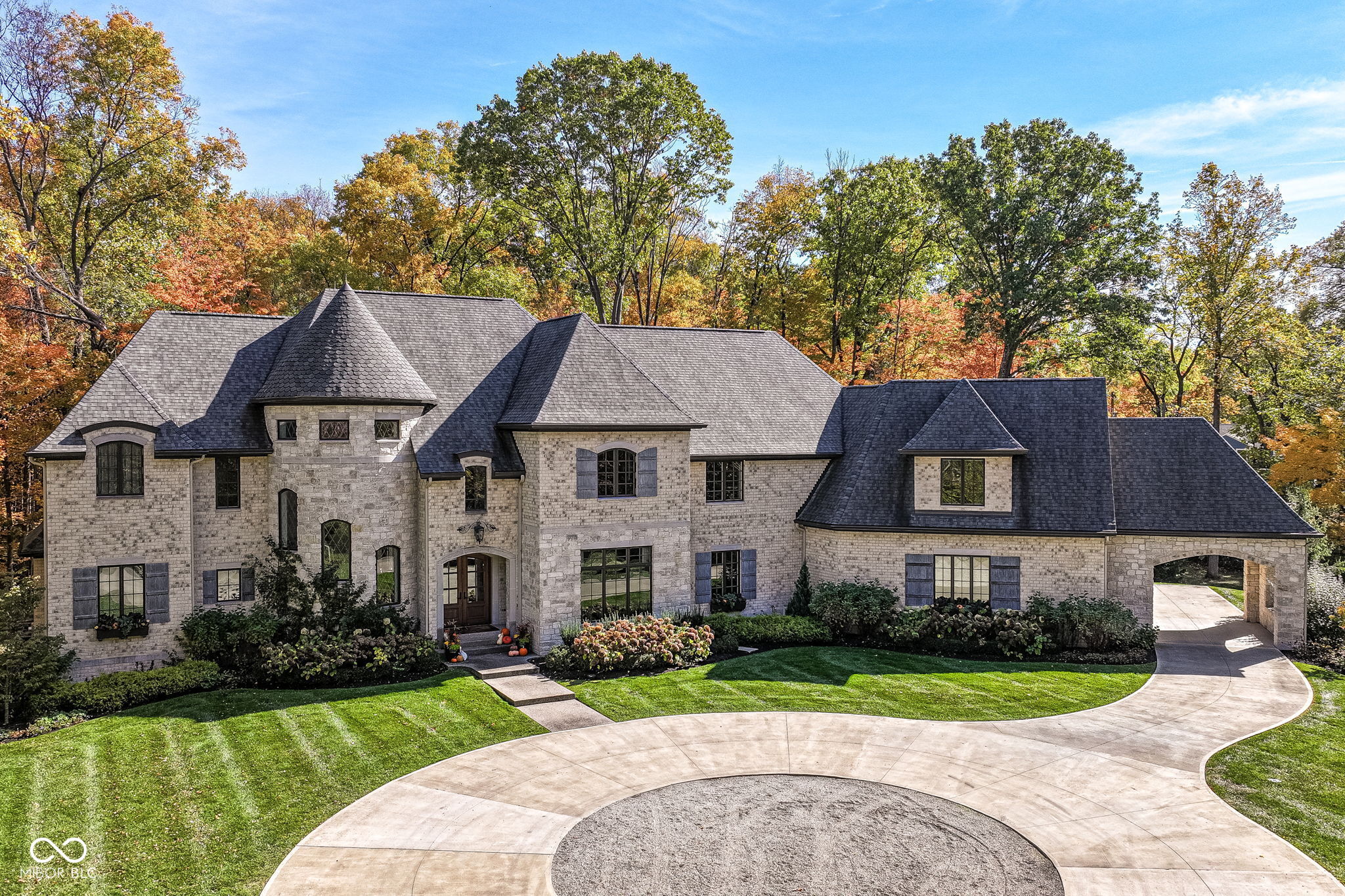 Exceptional custom home by Christopher Scott Homes on 4.15 wooded acres w shared pond in the heart of Zionsville.  The wooded lot, set away from the road, offers privacy, but very convenient to Zionsville's charming village restaurants & shops, and top notch Zionsville schools.  Spectacular French Country beauty built new in 2018, thoughtfully designed, well maintained, and one owner. 10,384sf, light & bright, travertine & white oak floors, vaulted ceilings w gorgeous beams, 5-6 Bedrooms, 5 Full & 3 Half Baths, 4 car garage.  Enter the front double doors into the spacious Foyer w 20' ceiling & travertine floors.  Follow the beautiful stone floors into the main entertaining area featuring the Great Room w lovely fireplace & vaulted ceilings w wood beams.  Kitchen is perfect for entertaining w 12' island, Amish maple cabinets, Thermador appliances including Double Refrigerator, Double Ovens, 2 Dishwashers, Induction Cooktop w Limestone Hooded Vent.  Spacious Dining Area & built-in banquette Breakfast seating offer many places to gather.  Adjacent 625sf Porch w vaulted wooden ceiling, fireplace, grill, fan, heater & Phantom auto screens adds lovely outdoor space.  Also on the main level is the Primary Suite and Office.  Upstairs, 3-4 BR, 3 Full Baths & Bonus Room.  Lower Level offers lots of room for entertaining w large Recreation space that includes pool table, shuffle board, 3 TV's plus Bar w 2 more TV's.  Beautiful Bar has a limestone countertop with leather finish, refrigerator, 2 sinks, dishwasher & ice maker.  Steps away is the temperature & humidity-controlled wine room w 500 bottle capacity.  Plus Exercise Room, BR & Bath, large storage area, & walk-out to the backyard.  1,356sf 4-car garage features EV plug, 3 large storage closets, perfect for bicycles, strollers, golf clubs, gardening equipment & more.  Backyard offers a fenced yard for pets and play, plus more yard, lovely woods, and shared pond to enjoy. Eagle Elementary, Zionsville MS, Zionsville High