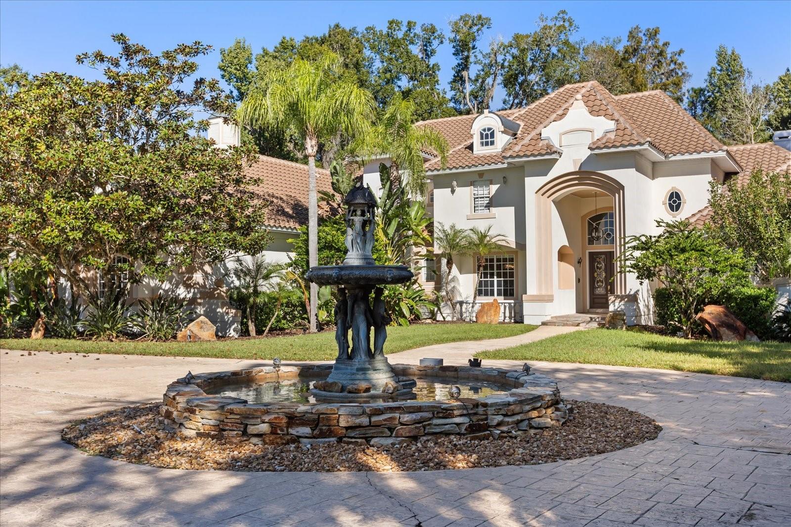 Welcome, to an elegant luxury estate blending architectural scale, premium finishes, and resort living in one of Lake Mary’s most private settings. Refined craftsmanship is evident throughout, with soaring ceilings, layered trim-work, rich bamboo and crema marfil marble floors, and remote-controlled blinds enhancing the home’s expansive living spaces.Designed for comfort and sophistication, the estate offers formal and casual living areas, plus a dedicated office framed with French doors.  The chef’s kitchen features granite surfaces, upgraded cabinetry, premium appliances, and a true butler’s pantry for service, storage, and prep.The primary master suite is located on the first floor, offering privacy and serenity with dual custom walk-in closets and a spa caliber en suite. Here, floor-to-ceiling tile, frameless glass, a stone-lined niche, upgraded flooring, and refined fixtures create a retreat tier experience. A second master suite upstairs acts as its own private wing, complete with a personal sitting area, walk-in closet, and a beautifully upgraded en suite bathroom.In total, the home showcases five spacious bedrooms, with additional guest suites featuring balcony access and fully updated baths with premium tile-work, modern vanities, and upscale fixtures.Separate from the main residence is a guest house, perfect for in-laws, extended stays, or private hosting. It includes its own upgraded bathroom with frameless glass shower enclosure, tile niche, modern vanity, and refined finishes, offering comfort, independence, and luxury equal to the main residence.The estate’s crown jewel is its dramatic, fully screened pool retreat, a breathtaking grotto style environment carved with stone formations, spa-style alcoves, integrated greenery, multiple lounge zones, and serene viewing angles from nearly every indoor space. This indoor-outdoor oasis delivers year round comfort, privacy, and destination level ambience.Every detail from upgraded baths, granite surfaces, induction cooking, customized closets, and butler’s pantry to the private office, dual master suites, guest house, and extraordinary grotto pool, reflects a standard of living rarely found. Thoughtful enhancements, newer roof(2019), entire house replumbed (2025), upgraded bathrooms, induction kitchen, remote blinds, customized closets, butler’s pantry, private office, multi-suite layout, and one of a kind pool design, define the elevated lifestyle of this exceptional estate.Experience luxury, privacy, and resort serenity at this exclusive residence!