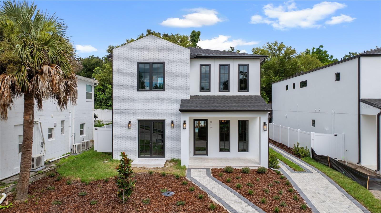 Exquisite new construction residence by esteemed builder Luih Homes, where timeless design meets modern sophistication in the heart of Orlando’s highly sought-after SoDo district. This exquisite home offers 3,632 square feet of thoughtfully curated living space, showcasing impeccable craftsmanship and elevated finishes throughout. From the moment you arrive, you’re greeted with picturesque lake views from the front of the home, setting the tone for this impressive home. Step inside to discover soaring ceilings, engineered hardwood flooring, and an expansive open-concept layout that seamlessly blends comfort and style. The designer chef’s kitchen is a showpiece, featuring custom cabinetry, waterfall-edge quartz countertops, and a full suite of premium Thermador appliances, perfect for both intimate gatherings and grand entertaining. Upstairs, a versatile loft provides additional living space ideal for a media room, playroom, or home office. The lavish primary suite is a serene sanctuary, complete with a spa-inspired bath boasting a freestanding soaking tub, an oversized walk-in shower, dual vanities, and spacious his-and-hers closets. Outdoors, enjoy a generously sized backyard oasis anchored by a sleek pool and sun-soaked patio, offering ample space for lounging, dining, and entertaining. A detached garage enhances both function and charm, while mature landscaping adds a layer of privacy and refinement. Ideally located just minutes from Downtown Orlando, premier shopping, dining, and top-rated schools, this exceptional home offers the perfect fusion of luxury, location, and livability.