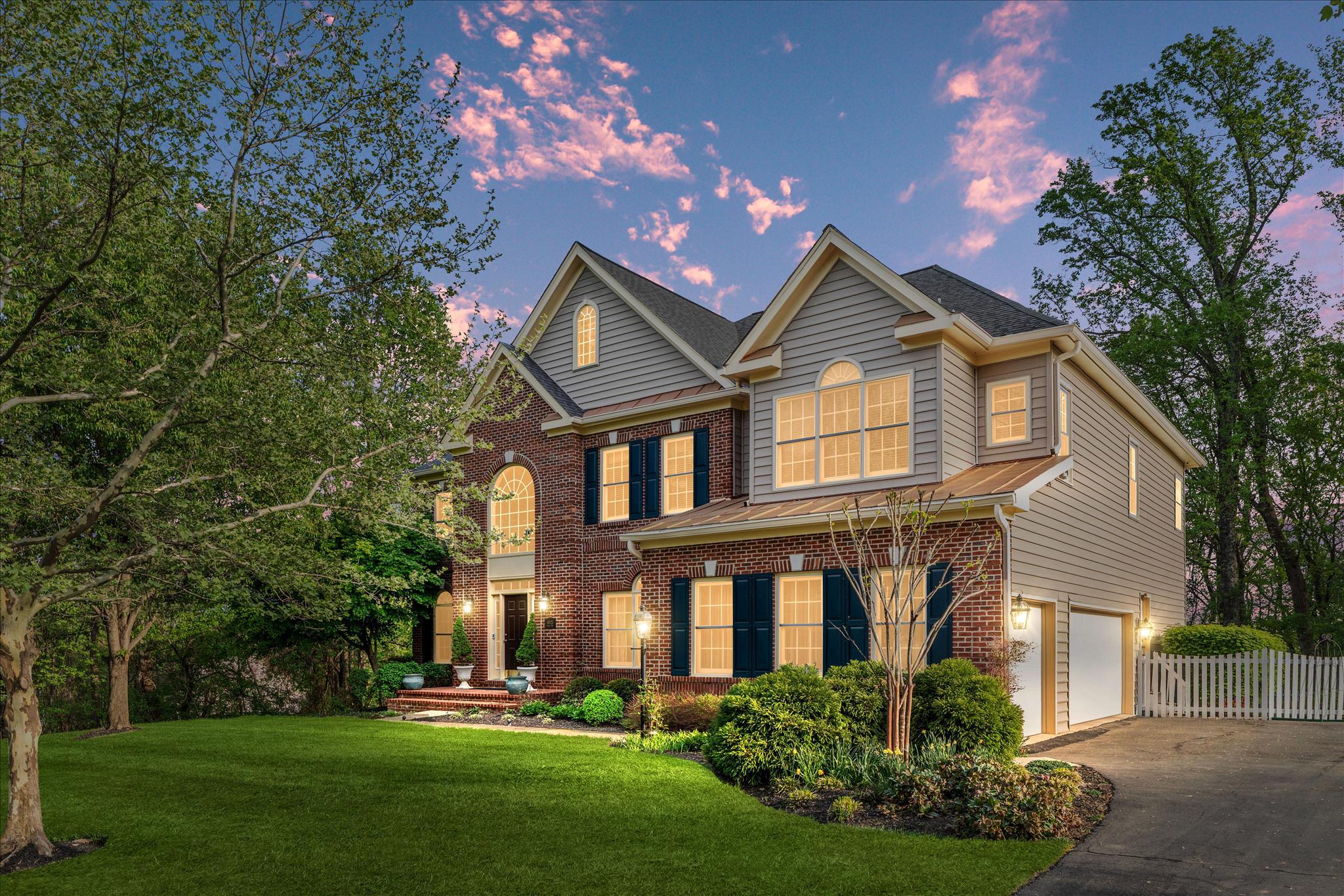 Tucked within one of Aldie's most established and desired neighborhoods, this brick-front home in The Marches sits on 1.27 private acres backing to woods and community open space, offering a sense of seclusion that feels increasingly rare in Loudoun County, without sacrificing convenience.From the moment you arrive, the mature tree canopy, generous lot, and quiet surroundings signal that something special awaits. A two-story foyer welcomes you inside, where natural light and an effortless open flow carry you through a main level designed for the way people actually live. The formal dining room, framed by detailed moldings, connects seamlessly to the kitchen, while a private study and soaring two-story family room anchor the back of the home. Here, a floor-to-ceiling stone fireplace commands the room, with views extending beyond to the deck and the wooded yard that unfolds behind it.The kitchen, fully renovated in 2025, is both beautiful and functional. Quartz countertops, double wall ovens, a built-in microwave, and a beverage fridge are anchored by a generous center island with seating - the kind of kitchen that handles a dinner party as effortlessly as a Tuesday morning. The adjoining breakfast room and sunroom open directly onto the expansive deck and fenced backyard, creating a natural flow between indoor gathering and outdoor living. A mudroom with drop zone and laundry area connects to the three-car side-load garage, which is also equipped with a dedicated EV charging outlet (240-volt, 50-amp).Upstairs, the primary suite is a true sanctuary. A tray ceiling, sitting area, and two walk-in closets set the stage, while the 2026-renovated bathroom elevates the everyday with dual vanities, a spa-inspired walk-in shower, and finishes that feel anything but ordinary. A junior suite enjoys its own private bath, two additional bedrooms share a well-appointed Jack and Jill bathroom, and a fifth bedroom offers the flexibility every household eventually needs, whether that means a home office, nursery, or dedicated guest space.The walk-out lower level is unfinished and full of possibility. With rough-in plumbing already in place for a full bath and direct access to the backyard and its wooded views, the foundation for a future rec room, home gym, or in-law suite is already set.Major updates and investments to protect your home long-term include the roof replacement in 2021 and the two exterior HVAC units that were replaced in September 2016, accompanied by a new basement evaporator coil installed the same year. Beyond the property itself, the location delivers. Situated in Loudoun County with easy access to Dulles International Airport, Route 50, and Route 15, this home offers the quiet of countryside living without the compromise. Brambleton Town Center and the Village at Leesburg are just minutes away for shopping, dining, and everyday errands, while Hal and Berni Hanson Regional Park offers trails and open green space close to home. The wineries, farmers markets, and timeless charm of Middleburg and historic downtown Leesburg are all within easy reach - a lifestyle that is genuinely difficult to replicate at this price point in this county.Thoughtfully updated, beautifully positioned, and ready for its next chapter - this is a home that invites you to slow down, settle in, and stay awhile.