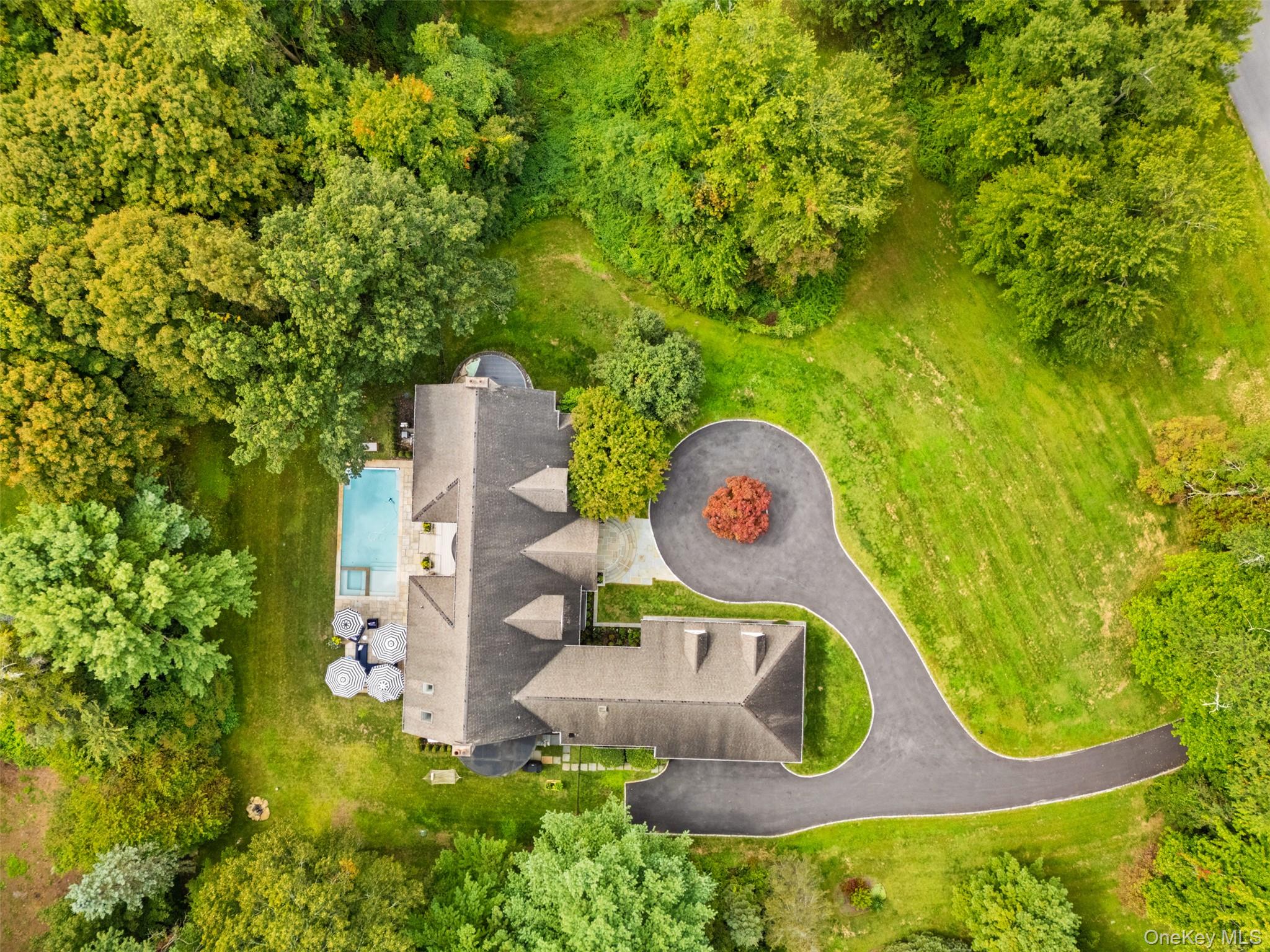 Nestled in the prestigious enclave of Bedford, NY and located in the Byram Hill School District,  9 Hobby Farm stands as an epitome of sophisticated living. Set back on a beautifully manicured, sought-after street, this expansive open concept home boasts a blend of elegance and modern comfort. The oversized first floor rooms seamless open into each other. The large living room with big windows, the family room with its double sided fireplace into the breakfast nook while the heart of the home is the newly renovated chef’s custom kitchen, which flows seamlessly into a grand breakfast nook and an oversized formal dining room. The home's layout is thoughtfully designed with both front and back staircases, leading to light-filled rooms that include a first-floor office or playroom, a mudroom, and a first-floor en-suite bedroom. Enjoy the luxury of three fireplaces throughout, enhancing the ambiance of this remarkable home. Upstairs discover 4 large bedrooms and 4 bathrooms.  Each bedroom is a serene retreat, complete with its own en-suite bathroom. The oversized primary suite is a sanctuary featuring a cozy fireplace, a private balcony, and vast walk-in closets.  Venture outside to your own private oasis with a large flat grass area, new Hamptons-style pool, complemented by a blue stone patio and Trex deck. Additional features include a 3-car garage, a generator, tons of closets, spacious laundry room on the first floor and an additional 3,000 square feet of unfinished space in the basement with good ceiling height. The well manicured sun filled spacious home has the perfect blend of style and functionality.