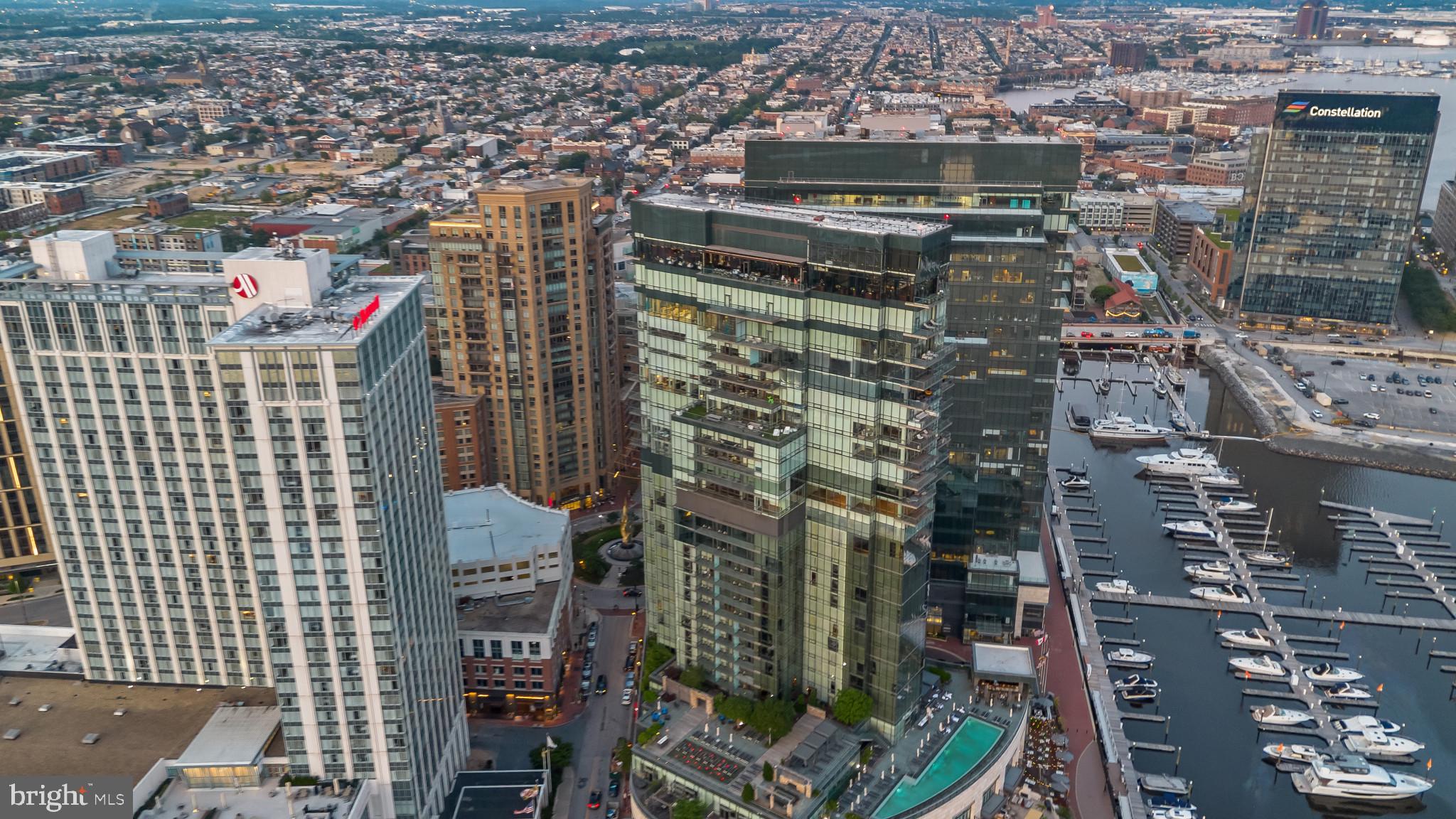 Welcome to the Four Seasons Private Residences in the heart of Baltimore’s Harbor East, where luxury, location, and lifestyle converge.  From the 21st floor, this gorgeous 1-bedroom, 1.5-bathroom residence offers spectacular views of the city skyline and harbor through floor-to-ceiling windows. This refined residence features rich walnut herringbone flooring and high-end finishes throughout. In the kitchen elegant cabinetry, a gas stove, built in microwave, and elegant quartz countertops create a warm space for cooking for family and friends. The primary suite includes a walk-in closet and a luxurious marble bathroom with double sinks and walk-in separate shower. As a resident in the Four Seasons, you’ll have exclusive access to the private 28th-floor amenity level featuring an indoor saltwater infinity pool, sauna, outdoor deck, fitness center, meeting rooms, and lounging areas — plus a dog-walking area for your furry family members. You’ll also enjoy full access to all hotel amenities, including the outdoor pool, large fitness center, and valet services. This property comes with one dedicated parking space in the garage with easy resident access. There are four on-site restaurants in the Four Seasons, and many amazing dining options just a short walk away in Harbor East and Fells Point. Shopping, parks, harbor activities, museums, and miles scenic waterfront walkways are all close enough to enjoy every day. Experience luxury living at the Four Seasons, it’s more than a residence, it’s a lifestyle.