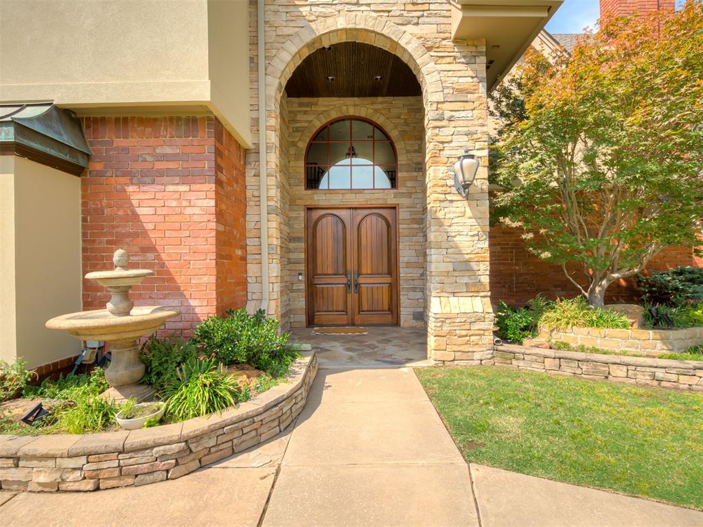 Experience luxury lakeside living in this stunning 5-bed, 5-bath waterfront estate set on 1.5 acres across two lakefront lots in an exclusive gated community. Designed for comfort, privacy, and year-round enjoyment, this home offers spectacular lake views, resort-style amenities, and exceptional craftsmanship throughout.A grand wrought iron staircase welcomes you inside, where expansive casement windows frame sweeping views of the water. All five bedrooms feature ensuite bathrooms, providing private retreats for family and guests. The primary suite includes a dedicated workout room and a private upstairs balcony overlooking the lake.Outdoor living is elevated with an in-ground pool, poolside cabana, full outdoor kitchen, and a firepit area perfect for gatherings. The stacked rock and stucco exterior, gated driveway, and beautifully maintained grounds create an impressive and secure setting.Additional features include a storm shelter, roof replaced one year ago, and a spacious 3-car garage equipped with heavy-duty storage racks.This exceptional property blends luxury, comfort, and natural beauty—offering a rare opportunity to own a private lakeside retreat with unmatched amenities and breathtaking views.
