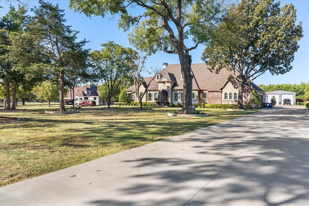 A rare blend of elegance, comfort, and Texas-sized space, this stunning 2017 custom residence rests on a pristine 1.28-acre homesite just outside the city limits of Allen, within the highly regarded Lovejoy ISD. Designed for both effortless everyday living and memorable entertaining, the home showcases an open-concept layout, refined finishes, and expansive outdoor amenities. Step inside to an inviting living and dining area anchored by a stunning multi-use fireplace that can be enjoyed as gas or wood-burning—perfect for cozy evenings or lively gatherings. The chef’s premier kitchen is a true centerpiece, featuring abundant cabinetry, a gas cooktop, and a generous granite-topped island that doubles as prep and serve space. A dedicated office provides quiet productivity, while the media room sets the stage for cinematic nights at home. With 4 spacious bedrooms and 3.5 well-appointed baths, the private quarters offer room for everyone. The 3-car garage adds convenience and storage, complementing the home’s thoughtful design and functional flow. Outdoors, the property truly shines: a dedicated grilling area, a substantial 50’×30’ covered shade structure, and expansive grounds with ample planting space create an idyllic backdrop for relaxation and play. Extensive parking—including covered spaces—adds welcome flexibility for guests, hobbies, or toys. Here, you’ll enjoy the serenity of country-like living with the convenience of Allen’s amenities just minutes away. Schedule your private showings now
