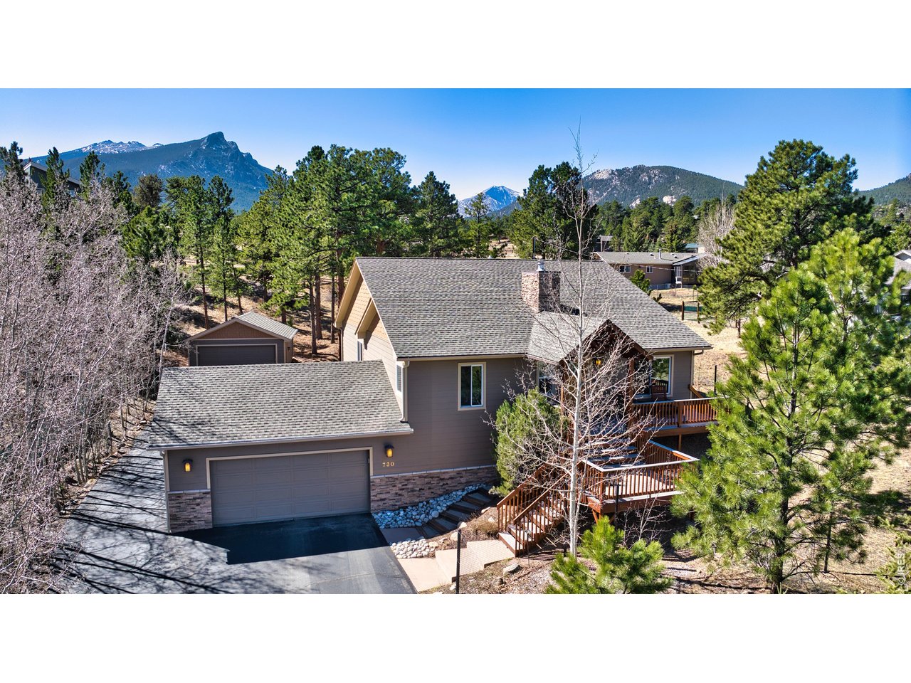 Experience the perfect blend of comfort, craftsmanship, and mountain living in this beautifully designed custom home tucked among the trees in Estes Park. Completely remodeled in 2013 by Westover Construction with luxury finishes and functional design, this home offers exceptional versatility for both full-time living and a peaceful retreat. Step inside to an inviting, open-concept main level featuring hickory hardwood floors, abundant natural light, and seamless flow between the living, dining, and kitchen. The well-appointed kitchen includes ample cabinetry, workspace, and a cozy dining area ideal for everyday living or entertaining. Enjoy year-round comfort with multiple heating sources: in-floor heating, a wood stove, and a pellet stove, so you can heat the home the way you want. The layout is designed for flexibility and privacy, featuring two primary suites-one located on the main level and a second spacious ensuite on the lower level, perfect for guests or multigenerational living. The lower level also offers a generous great room with walk-out access, creating an ideal space for relaxing, entertaining, or hosting extended stays. Outdoor living is just as impressive, with a large elevated deck off the main living area-perfect for enjoying peaceful mornings, evening sunsets, and the surrounding natural beauty. Car enthusiasts and outdoor adventurers will appreciate the rare dual-garage setup, including an attached garage and a detached two-car garage, offering abundant space for vehicles, RVs, trailers, and all your mountain toys. Additional outbuildings, including a woodshed, enhance the property's functionality and charm. Surrounded by mature pines and set in a tranquil setting, this property delivers the privacy and lifestyle buyers seek, while still being conveniently located near all that Estes Park has to offer. A true mountain retreat combining custom design, flexible living spaces, and exceptional storage for all your Colorado adventures.