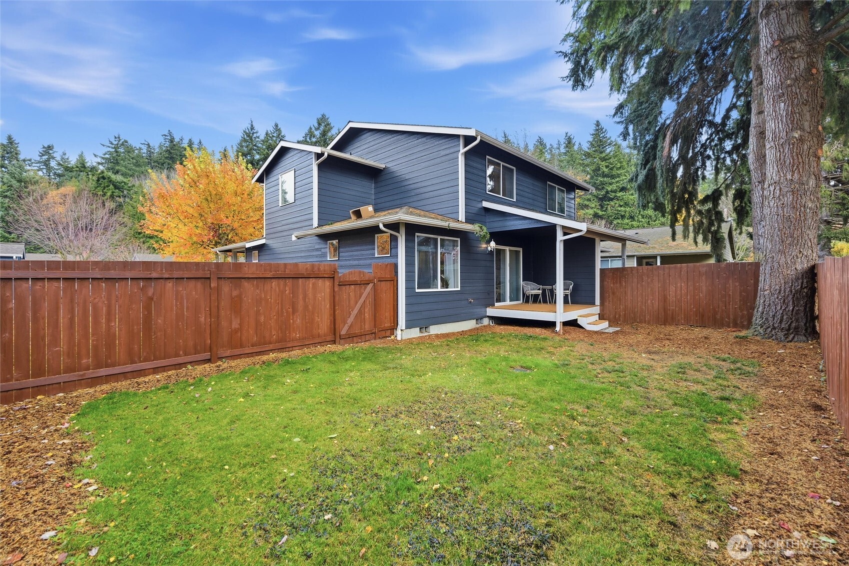 Fully fenced large backyard with cozy covered back deck.