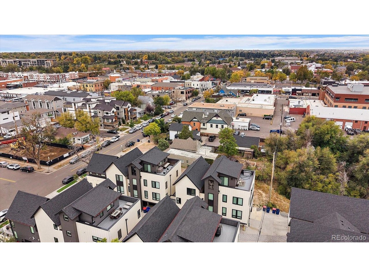 Modern construction steps from Historic Main Street is one of downtown Littleton's rarest opportunities. Built in 2021, this Curtice Village townhome is one of just 14 homes on a quiet residential block, close to everything downtown yet tucked far enough away to come home to calm. In a neighborhood where most townhomes date back decades, this one skips the renovation list entirely, with modern finishes ready from day one. Three stories of light, bright and breezy living deliver trendy, chic style and flexible space on every level. The lower level entry has a mud area with direct access to the private one-car garage. Upstairs, the open and airy main level features vaulted ceilings, a private balcony for a quick outdoor escape and an expansive kitchen with a center island for bar seating. A dedicated work area or flex space connects the kitchen to the great room, and a powder room serves guests. The top floor is a true primary retreat with dramatic vaulted ceilings, a huge walk-in closet, laundry with washer and dryer included, and an open desk nook at the top of the stairs for a home office, reading corner or workout space. Low HOA dues cover water, trash and common area maintenance to keep life simple. The HOA permits short-term rentals, so owners have options for extra income, subject to City of Littleton licensing. A home you will love living in, with the flexibility to earn when life takes you elsewhere. Cross the street for coffee at Hearth, then make your way to Cafe Terracotta, The Melting Pot, Smokin Fins, Jake's Brew Bar, Black + Haus Tavern, ViewHouse, Palenque, La Vaca Meat Co. and numerous boutiques, bakeries and bistros. Enjoy First Friday Arts and the Town Hall Arts Center. The Littleton/Downtown light rail station is three blocks away with direct C Line service to Union Station, and Little's Creek Trail connects you to the Mary Carter Greenway, South Platte Park, Hudson Gardens and Littleton Golf & Tennis.