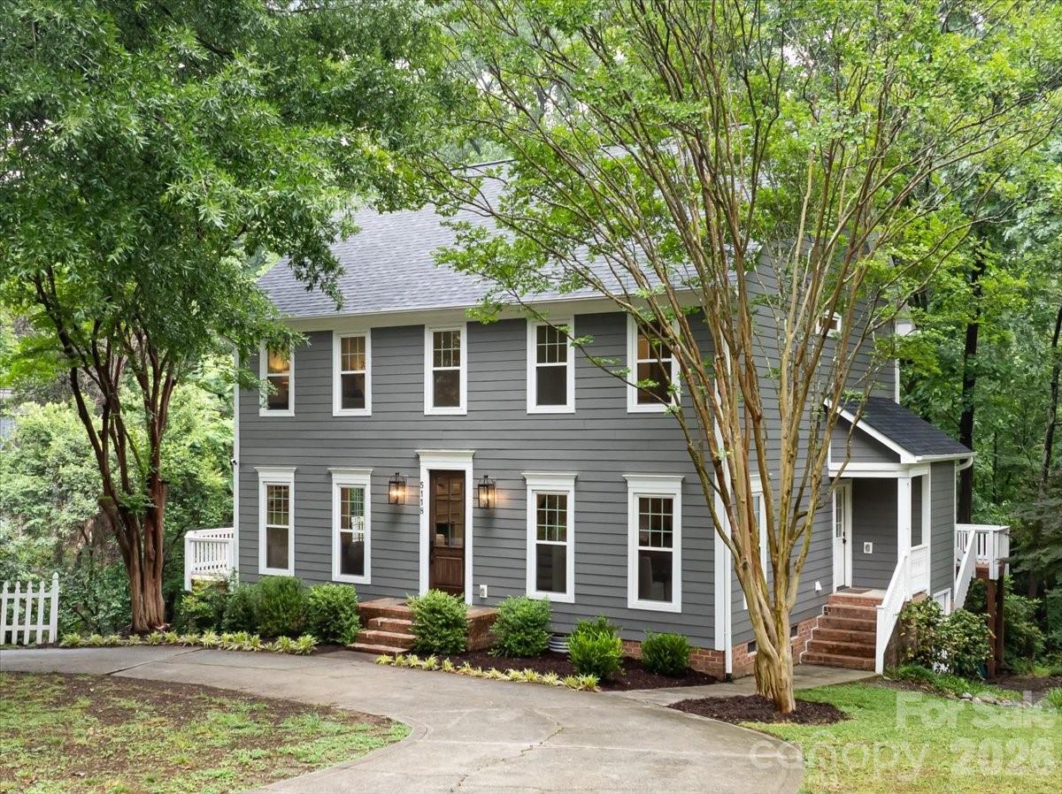 Tucked away on over half an acre in the heart of Charlotte, this stately and meticulously maintained 4-bedroom home offers the rare combination of everyday convenience and serene privacy. Just a short walk to the JCC and close to everything, the setting feels wonderfully secluded—complete with frequent morning visits from the property’s beloved local heron, “Hank.” Inside, hardwood floors flow throughout a smart, livable floor plan featuring a two-story foyer, formal dining room, flexible family room/office, and a spacious eat-in kitchen with stainless steel appliances, generous prep space, and excellent storage. The kitchen opens beautifully to the living room, creating an easy, connected layout for daily living and entertaining. Upstairs, the primary suite features a large walk-in closet with built-in shelving and a well-appointed bath with ample counter space and a glass-enclosed shower. Three additional bedrooms and an additional full bath complete the upper level. Recent improvements include a NEW ROOF, newer mechanicals, underground drainage, and a refinished wrap-around deck overlooking the private backyard. A partially encapsulated walk-in crawlspace offers excellent workshop and storage potential. Move-in ready, beautifully cared for, and set in one of the area’s most convenient yet tranquil locations.