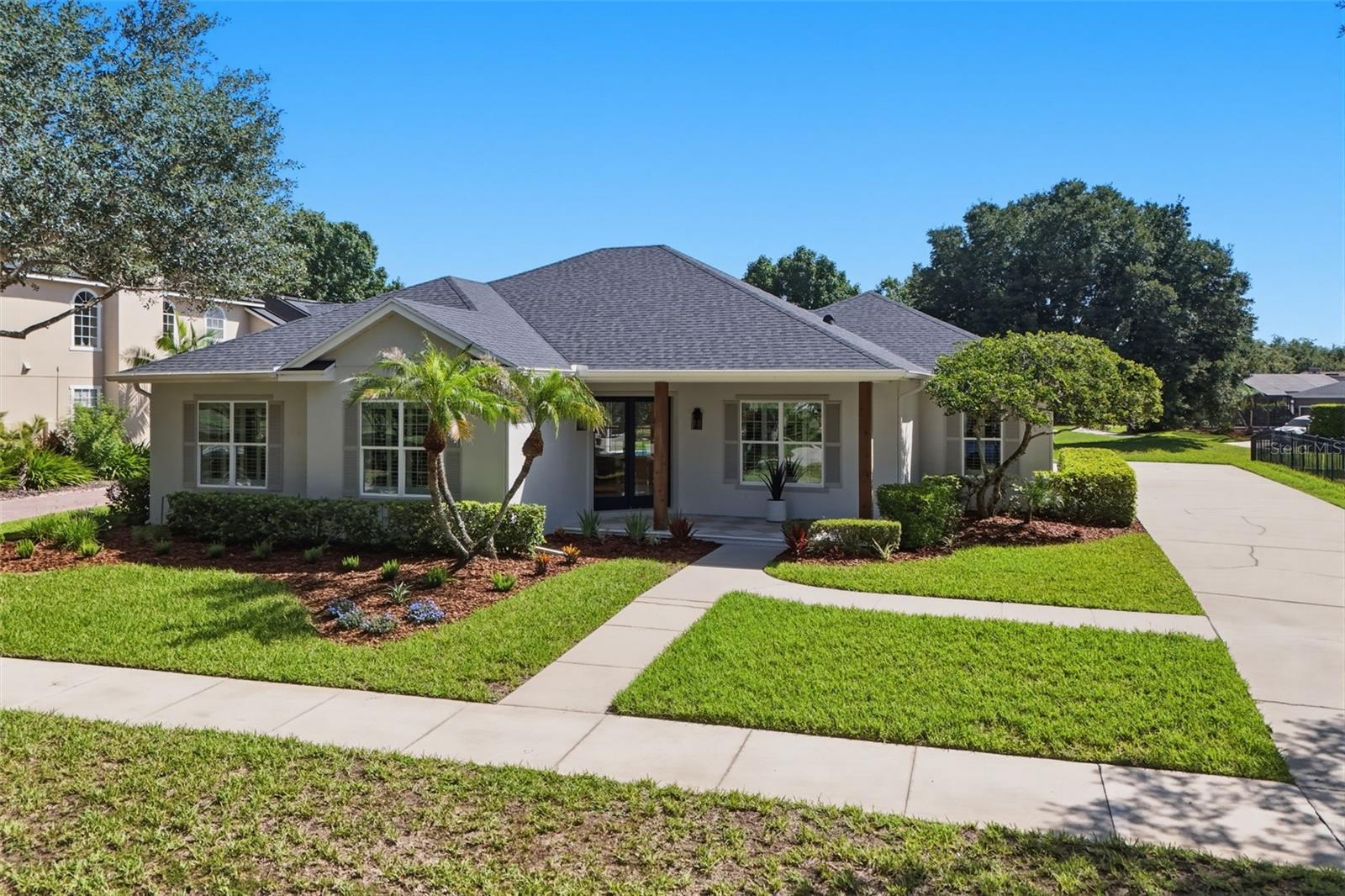 Another Signature Masterpiece by KJ Group Investments! Truly move-in ready and impeccably transformed, this residence delivers the rare combination of single-story living, architectural elegance, and luxury lifestyle. Perfectly positioned on an oversized ¼-acre homesite along one of NorthLake Park's most enchanting, canopied oak-lined streets, this extraordinary residence enjoys breathtaking conservation and pond views, offering a rare combination of luxury, tranquility, and privacy in the heart of Lake Nona. This stunning renovation transforms the original floor plan into an elegant 5-bedroom, 3 full-bath luxury residence, where custom craftsmanship and timeless design define every space. A new double-entry front door welcomes you onto an inviting front porch showcasing rich wood-paneled ceilings, wood columns, and refined tile flooring. Step inside to delight in an expansive, light filled open-concept floor plan enhanced by premium luxury vinyl plank flooring, custom trim work, elevated architectural details, and thoughtfully curated designer lighting. Striking wood-paneled ceilings are found in both the living room and the luxurious primary suite, while custom feature walls, elegant millwork, and designer finishes provide a level of craftsmanship rarely found in today's market. At the heart of the home, the spectacular chef's kitchen is both functional and breathtaking, featuring custom cabinetry, luxurious quartz countertops, a dramatic oversized island, NEW premium stainless-steel appliances, and a stunning custom architectural hood vent that serves as the room's centerpiece. This is a space that is equally suited for everyday living and grand entertaining. The redesigned floor plan incorporates exceptional custom-built living spaces, including a private home office, spacious walk-in pantry, beautifully appointed laundry room with custom cabinetry, integrated storage solutions, and built-in cabinetry that adds both elegance and practicality throughout the home. The inviting living room is anchored by a beautiful, tiled designer fireplace, with built-in cabinets, creating a warm and welcoming focal point. The luxurious owner's suite, and spa-inspired bathroom create a private sanctuary. The stunning ensuite showcases a walk-in shower, premium porcelain tile, designer vanities, upscale plumbing fixtures, and generous walk-in closets. Two additionally beautifully renovated bathrooms continue the home's refined aesthetics and timeless elegance. Step outside to your own private pool that overlooks peaceful conservation and serene pond views. The backyard oasis offers exceptional privacy and the perfect setting for entertaining, relaxing, and enjoying Florida's year-round outdoor lifestyle. Designed to provide years of peace of mind, this exceptional residence features a NEW ROOF, NEWER HVAC, NEWER WATER HEATER, NEW GREEN ENERGY EFFICIENT WINDOWS, and the RESURFACED POOL. Located in the highly sought-after NorthLake Park community, residents enjoy parks, playgrounds, scenic walking trails, YMCA membership, top-rated schools, and convenient access to Medical City, Orlando International Airport, premier shopping, dining, championship golf, and major highways. This home is a custom-crafted luxury residence where exceptional design, masterful craftsmanship, and one of NorthLake Park's most desirable oversized conservation homesites come together to create one of Lake Nona's most remarkable offerings. Schedule your private showing today!