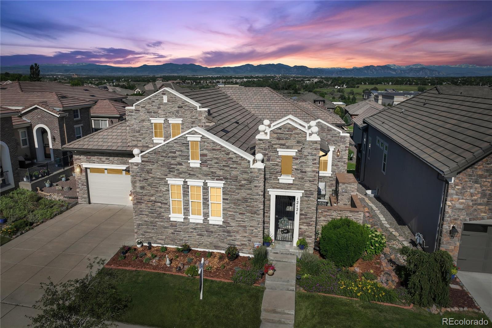 MOUNTAIN VIEWS, LOCATION, MAINTENANCE-FREE, PATIO HOME, MOVE IN READY! Nestled in the sought-after Country Club Highlands neighborhood, this STUNNING updated, open-concept, ranch-style John Laing floor-plan OFFERS 3 bedrooms, 5 baths, 3-car garage, finished walkout basement with amazing views of the full mountain range! Unobstructed views can be appreciated from the kitchen, great room, and primary bedroom. The spacious private gated front porch has a built-in outdoor gas fireplace, slate floors, and seating for entertaining. Located on the main floor is an office, the laundry room, a large dining room, a spacious great room that adjoins the large kitchen, and access to the outdoor upper deck. The kitchen has been upgraded with stainless steel appliances, a gas cooktop, custom cabinets, granite countertops, double ovens, a walk-in pantry, a butler's pantry, and an oversized island, a chef's dream. The primary bedroom is quiet and features a luxury 5-piece bath, new flooring, and access to the deck. The secondary bedroom with a private ensuite. The basement features a large family room area, a wet bar, a 3rd guest bedroom, a gym/storage/craft room, a 3/4 bathroom, and a powder bathroom, providing a complete living space for an additional family member. The lower-level covered patio is another wonderful space for guests and pets. Upgrades throughout and NEW items include: tile roof, furnace, tankless water heater, interior and exterior paint, refrigerator, stove, and carpet. Nothing to do other than unpack and enjoy this fantastic community and all the amenities it provides, including a pool, clubhouse, tennis/pickleball courts, lawn & landscaping maintenance throughout the year, snow removal to your front door, and perfect "lock and leave". Close to walking/biking trails, the Ranch Country Club & Legacy Ridge Golf Course, Hwy 287, Hwy 36, & I-25, walking distance to various restaurants, Hyland Hills Fitness, cleaners and other businesses.