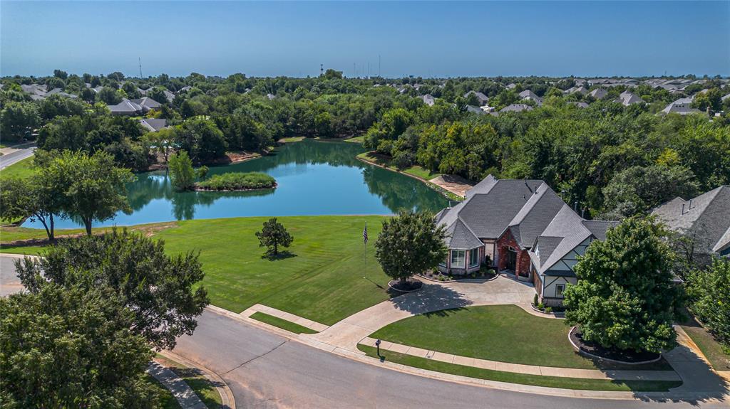 WOW!! WHAT A RARE FIND!!! Stunning views of the water! You feel like you are the only home on the water with greenbelt on one side and water all across the back! 1/3 acre lot mol!  Entertain on the extra large covered patio or balcony and enjoy the view! EXTRA BONUS is the gorgeous chlorine pool with updated pebble tech finish! This backyard feels like your own private resort! NEW ROOF AUGUST 2025!! Coffee Creek also features a community pool, clubhouse w/gym and basket ball courts! Kitchen features stainless steel appliances, double convection ovens, walk-in pantry, granite counters, island, crown molding, speakers, plantation shutters & wood floors. Family room also has wood floors, crown molding, speakersand fireplace with gas logs. Cozy formal dining with wall of windows, speakers, soaring ceiling and plantation shutters. Good size utility room with sink and plenty of storage. Study with wood floors, door to patio, wood beam ceiling and fan. Half bath located in hall just off the study. Primary bed down w/door to patio for easy pool access, wood floors, crown molding, speakers & walk-in closet. Spacious primary bath with whirlpool tub, large shower, 2 sinks and make-up vanity.  Extra large 2nd bed up with walk-in closet, speakers & plantation shutters. 3rd bed up with fan, plantation shutters & walk-in closet. Hall bath w/shower services the 2nd & 3rd bed. 4th bed up w/fan, walk-in closet and full bath w/tub. This bath also has access to the bonus room. Generous size bonus room up with 2 large walk-in closets, fan and door to the balcony could also be used as a 5th bedroom if needed.  Home also features 2 driveways! 1 driveway to service the 2 car garage entrance, the other driveway services the 3rd car garage entrance. Only 1 extra large garage w/2 points of entry that holds 3 cars....very cool and unique set up! Don't miss this opportunity to own your own resort style living experience!