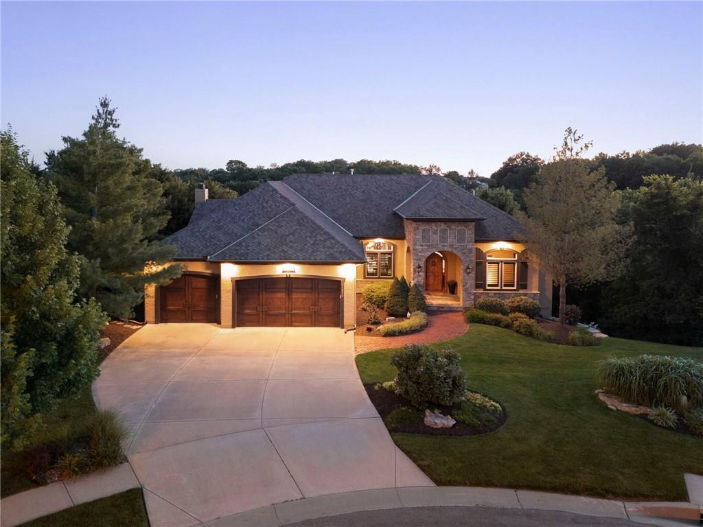 Nestled on a rare 1.4-acre wooded cul-de-sac lot in sought-after Cedar Creek, this exceptional Starr-built home offers the perfect combination of luxury, privacy, and outdoor living. Since 2022, the property has been extensively enhanced with more than $366,000 in improvements, creating a truly turnkey experience.The backyard is a standout feature, professionally redesigned with extensive hardscape, retaining walls, landscape lighting, irrigation, fencing, mature landscaping, and a rebuilt deck and patio to create a private resort-style retreat. Whether entertaining guests or enjoying a quiet evening surrounded by trees, the outdoor spaces are simply extraordinary.Inside, thoughtful updates include a Magnolia smart home and entertainment system, flooring upgrades, garage enhancements, fireplace improvements, lighting updates, storage solutions, and numerous additional improvements throughout. Walls of windows capture beautiful wooded views while filling the home with natural light.Offering the rare combination of neighborhood living, mature trees, privacy, and exceptional outdoor spaces, this Cedar Creek property delivers a lifestyle that is difficult to replicate. Conveniently located within the award-winning Olathe School District and close to golf, pools, trails, pickleball, tennis, dining, and shopping.