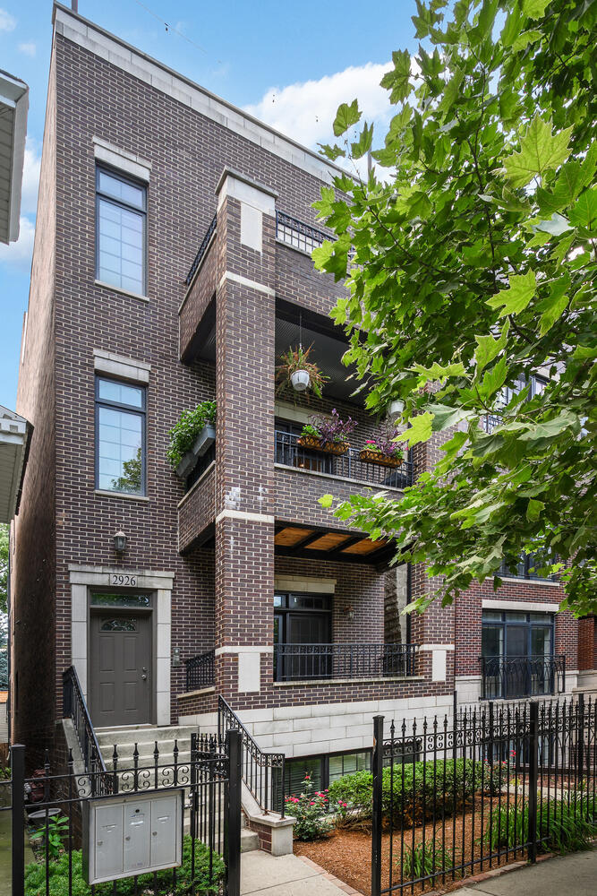 Welcome to 2926 N Damen Ave Unit 2, a beautiful 2 bed, 2 bath condo built by Barrett Homes in an all-brick, three-unit building steps from Hamlin Park. Unlike most middle units, this one includes half of the garage roof deck, in addition to front and rear private outdoor spaces, a true outdoor living trifecta.    Inside, you'll find warm hardwood floors throughout, tall ceilings, detailed crown molding, and elegant custom millwork. The open-concept living and dining area is anchored by a wood-burning fireplace with gas starter and opens to a covered front terrace perfect for grilling or lounging. The kitchen features 42" walnut cabinetry, a large breakfast bar, and stainless steel appliances from Bosch, JennAir, and GE Profile.    The spacious primary suite includes a walk-in closet and a spa-like bathroom with a dual-sink vanity, whirlpool tub, and a separate steam shower with rain head and body sprays. The second bedroom is ideal for guests, an office, or both. In-unit laundry and garage parking included.      Additional upgrades include a brand new A/C, furnace, and hot water heater (Sept 2024) and a new washer/dryer (April 2025) for peace of mind and long-term comfort.    All in a quiet, walkable location - steps from Hamlin Park, and the shops and restaurants along Roscoe and Belmont.