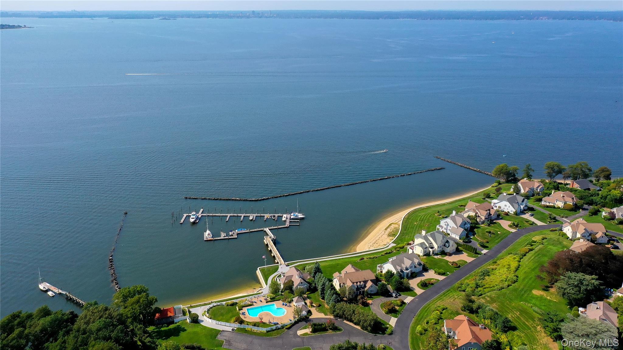 WATER, WATER EVERYWHERE!  Located in prestigious Legend Yacht & Beach Club, this pristine waterfront residence offers a rare opportunity to enjoy luxury coastal living with breathtaking panoramic waterviews & magnificent sunsets from nearly every room.  Designed for both elegant entertaining and relaxed everyday living, the home is filled with natural light and showcases an effortless flow of beautifully appointed living spaces.  This exclusive gated community offers an unmatched lifestyle with private marina where every owner enjoys their own boat slip, a stunning two-story clubhouse, Sound Side swimming pool, indoor tennis and pickleball courts, tranquil fountains and beautifully manicured gardens throughout the community.  An extroadinary offering combining privacy, luxury amenities and resort style waterfront living. A property to enjoy all year long or a fabulous Hamptons alternative only 26 miles from NYC.  Golf Rights also included at the Glen Cove Golf Course