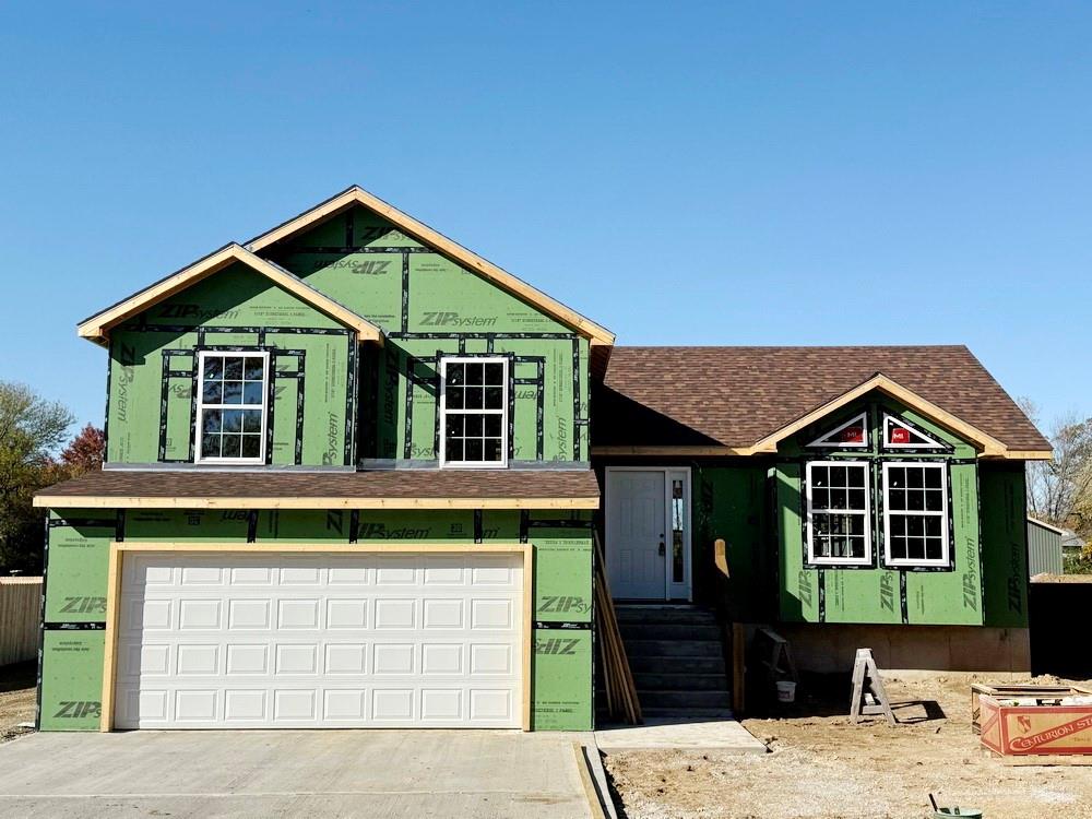 New-Built Home on South Side of El Dorado Springs.
Be the first to own this modern, new-construction home in El Dorado Springs, Missouri located on a nice lot near the south edge of town.  The 3 bed, 2.5 bath contemporary, California Split style home with total 1,661 sq ft will be completed in early January 2026 and ready for its first occupant.  The tri-level home will feature slick finishes with an open concept living room, kitchen, and dining on the main level. The main level is tastefully designed to maximize the spacious feel by including vaulted ceilings, large, beautiful windows, and a decorative balcony. In the kitchen there will be custom wooden cabinets and an island with granite countertops, and appliances will be included, making it a functional and attractive central hub of your home. The 12’ x10’ deck offers additional space to dine and entertain just outside the kitchen. The main level opens seamlessly to the lower-level family room offering additional space for residents and guests to spread out. Also on the lower level is the utility room, a half bathroom, and the 20’x20’ 2-car garage. Additionally, the backyard can be accessed from the lower level where a 15’x6’ patio is another great space to enjoy the outdoors. The 3 bedrooms are all together on the upper level of the home. The 14’x13’ primary bedroom has a walk-in closet as well as an en-suite bathroom with full-sized walk-in shower. The 2 guest bedrooms share the full hall bathroom also on the upper level. As a bonus, the home has 552 square feet of additional all-concrete storage space under the main level of the home that is easily accessed from the lower level. This home will feature an attractive rock face with low maintenance vinyl siding on the remaining 3 sides. A buyer who puts this home under contract soon may have an option to select some interior color choices possibly including flooring, paint, cabinet stain, and granite. Call soon on this great opportunity for a brand-new home!!