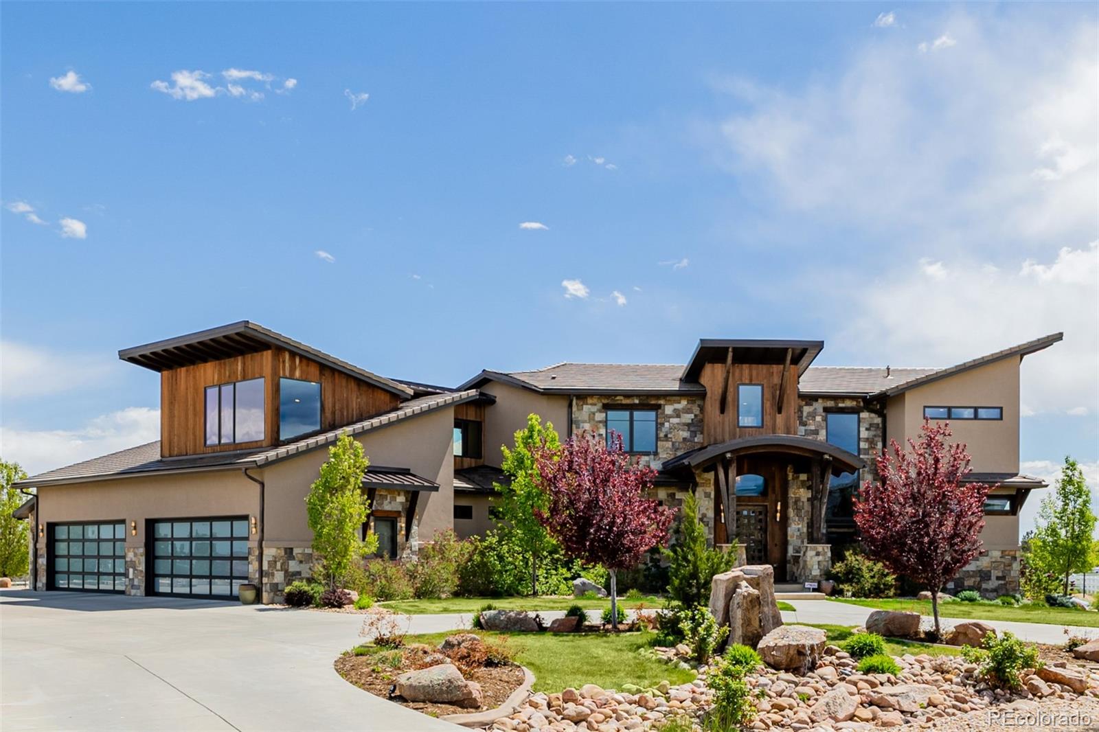 THE FRONT RANGE ESTATE - Welcome to your luxurious retreat in the coveted Spruce Meadows neighborhood. This contemporary mountain-style home showcases unparalleled craftsmanship and attention to detail. Vaulted ceilings create a grand, spacious atmosphere, while walnut floors throughout the home, including the primary bedroom, add warmth. The gourmet kitchen is a chef's dream with Jenn-Air appliances, granite countertops, main and prep sinks, 2 dishwashers, 2 oversized islands, microwave/speed cooker, warming drawer, wine fridge, ice machine, and induction stove. The main-floor primary suite includes a cozy seating area, fireplace, a lavish bath with radiant floors, steam shower, freestanding tub, and dual sinks, and a grand walk-in closet with built-in dresser island and floor-to-ceiling shoe racks. The 4-car garage features 2 EV charging stations and ample storage. The polished concrete walk-out basement offers a full kitchen, home gym, bedroom, and bath. Upstairs, 3 en-suite bedrooms with walk-in closets and a loft with built-in desk and shelves provide space for relaxation. A dedicated office includes built-in storage and a half-bath. The backyard is perfect for entertaining with a lighted full-court basketball court with pickleball lines, a large TimberTech deck, sunken patio, and natural gas hookups for a grill and fire pit. The rounded driveway adds curb appeal. Experience luxury living at its finest—schedule your visit today.

Property video link: https://vimeo.com/1080527833?share=copy