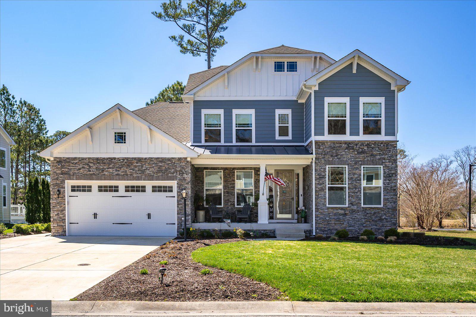 11634 Maid At Arms Ln, Berlin, MD — Built in 2019, this former model home offers over 3,100 sq ft of upgraded living space and is ideally located within the gated golf course community of GlenRiddle, in close proximity to clubhouse amenities. This 3BR, 2.5BA home features a spacious open layout with engineered hardwood flooring, hardwood stairs, walls enhanced with custom wood trim and decorative accents, and upgraded lighting fixtures throughout. The chef’s kitchen is designed for both function and style, featuring a large island, quartz countertops, stainless steel appliances, gas range with hood, double wall ovens, soft-close cabinetry, pull-out drawers, dishwasher, disposal, butler’s pantry, walk-in pantry, and abundant storage. Just off the kitchen is a casual dining area with French doors that open to the screened porch, creating an easy indoor-outdoor flow. The main living area is anchored by a gas fireplace with custom tile surround extending the full height and width, is flooded with natural light, and opens to a sun deck, creating a bright and inviting space for everyday living and entertaining. The primary suite includes a tray ceiling, plantation shutters, walk-in closet, dual vanity, and a spacious walk-in shower with multiple shower heads and ceramic tile, along with a private water closet. The second bedroom features custom hand-painted wall artwork, while the third bedroom offers a walk-in closet and additional storage. Additional interior features include a dedicated office, loft area, mudroom with built-ins, and a full laundry room with utility sink. Built for efficiency and durability, the home includes gas forced hot air with dual-zone HVAC, AprilAire dehumidifier, encapsulated and insulated crawl space with 4-ft height, interior access via door and steps, offering a large usable storage area, alarm system, and a garage equipped with a mini-split HVAC system, recessed lighting, and side entry door. The exterior showcases a combination of stone and siding, a decorative garage door, and a welcoming covered front porch suitable for a sitting area, creating strong curb appeal. Exterior features also include a screened porch and sun deck, Gutter Guard system, paver fire pit, irrigation system, and an extra-wide driveway. HOA includes lawn maintenance for added convenience. A rare opportunity to own a builder’s showcase model with upgraded architectural features throughout in one of Berlin’s most sought-after communities, offering resort-style amenities including golf, marina, pool, fitness center, and tennis — all just minutes to Ocean City beaches.
