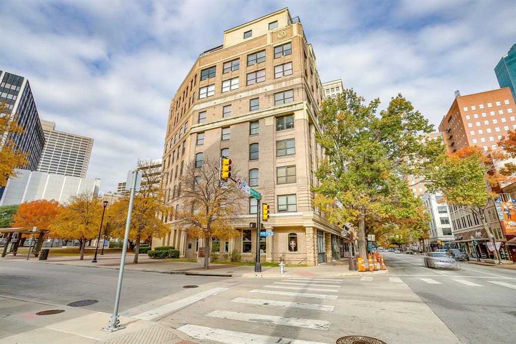Enjoy downtown living at historic Houston Place Lofts. Open loft with exposed brick and travertine tile. Corner unit with seven windows. Beautiful view of the Flatiron Building. Open kitchen-living, separate bedroom, walk-in closet, updated bathroom and fresh paint. Same floor parking space. Secured entry to both the building and garage with views of downtown. Next door to entertainment, dining, shopping, and much more, like museums, fireworks. Come and make this one yours!-----------------------------------------------------------------------------------Tenant to be billed Flat $100 monthly for Spectrum Internet Ultra (600 Mbps) and TV Essentials (70+ channels via the Spectrum app), water, garbage service, and two garaged parking spots.