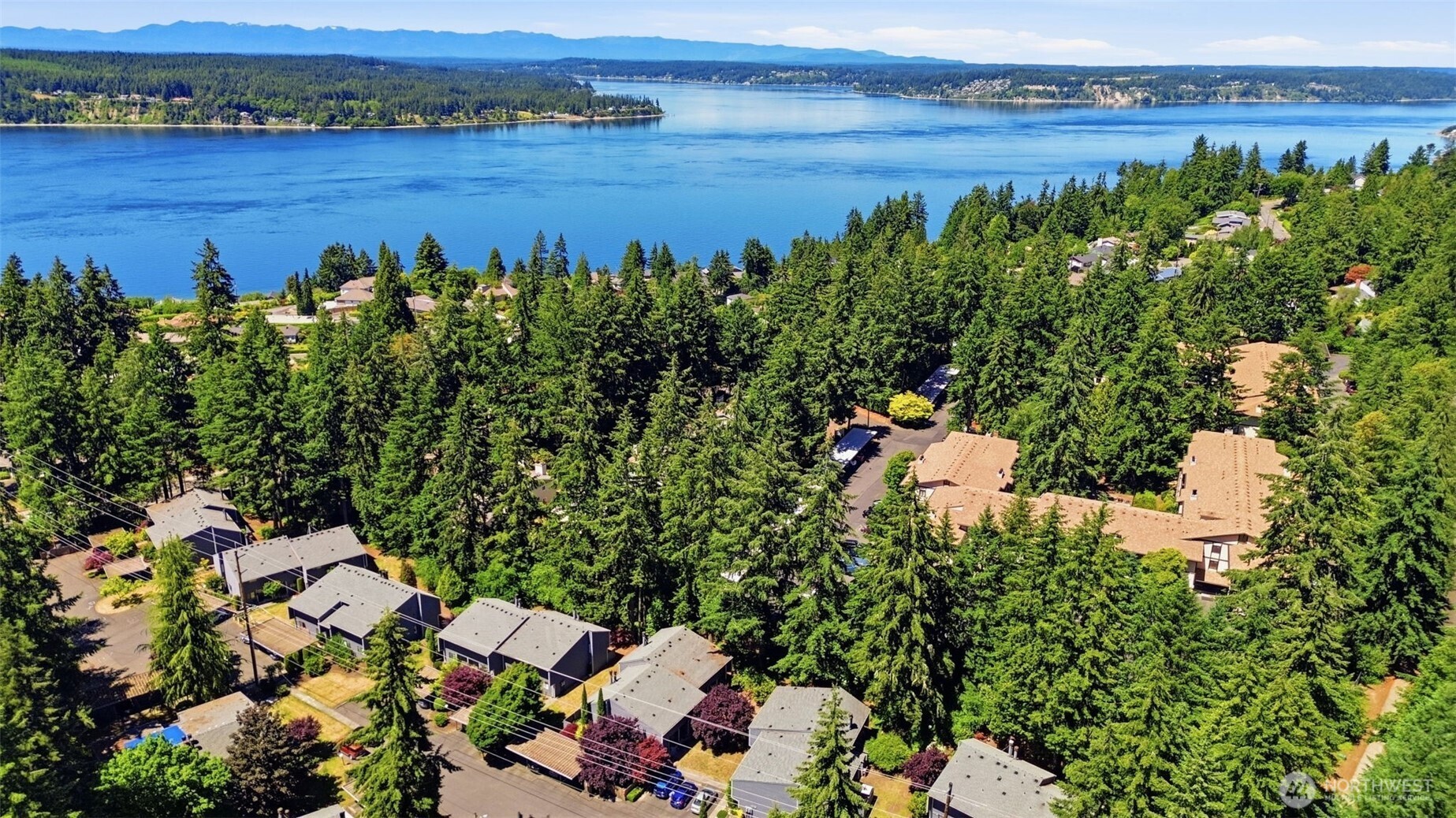 WELCOME TO GRANDVIEW SQUARE CONDOMINIUMS, where easy living meets an exceptional location just minutes to Chambers Bay! This beautifully maintained 2 bed 1.25 bath home offers comfort, low maintenance, convenience and privacy within a charming community setting. The inviting floor plan features luxury vinyl plank flooring, carpeted spaces, a cozy wood-burning fireplace, and thoughtful updates throughout. The functional kitchen and dining area flow seamlessly into the main living space. From the living room, a sliding glass door opens to a private fenced patio, ideal for relaxation or time with friends and family. Upstairs, you'll find two spacious bedrooms with large closets and ample storage. Community amenities include a designated covered parking space and plentiful guest parking. Perfectly located near UP schools, shopping, restaurants and parks!