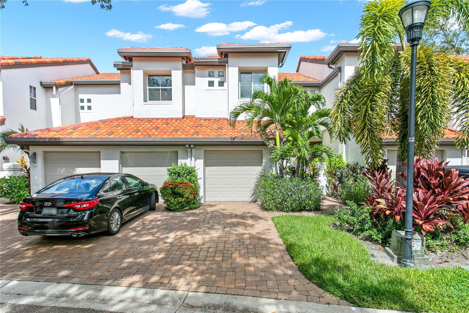 Experience elevated coastal living in this impeccably maintained and beautifully updated Harbour Island townhome, set within a desirable community offering 24-hour gated security. Harbour Homes feels private, peaceful, and tucked away while placing you moments from everything downtown Tampa has to offer. Step inside and you are greeted by abundant natural light, soaring ceilings, and a bright, open layout designed for comfortable everyday living and effortless entertaining. The kitchen opens to the main living area, where new French doors lead to a private deck—perfect for seamless indoor-outdoor living. Thoughtful updates throughout the home include shiplap accent walls, luxury vinyl plank flooring, and an updated powder bathroom conveniently located on the first floor, adding warmth, style, and everyday functionality.Upstairs, the spacious primary suite offers high ceilings, an oversized, custom-designed walk-in closet, and a beautifully remodeled spa-like bathroom, creating a true retreat. The second bedroom also features an en-suite bathroom and a custom designed closet to maximize space and minimize clutter. Enjoy the added benefit of a whole house water softener and upstairs laundry for convenience. Toast the sunset from your private deck while overlooking the neighborhood courtyard, complete with a pavered pathway, peaceful fountain, and lush landscaping. This home is also just steps from the expansive community pool and spa that features a heater/chiller for comfort all year long. A major 2026 community enhancement included the replacement of all roofs throughout Harbour Homes, adding peace of mind, improved protection, and long-term value for homeowners. Nestled in one of Tampa’s most sought-after locations, this home offers effortless access to the city’s thriving downtown scene. The Harbour Island Marina is close by and one of the many benefits of living here is the opportunity to purchase/own a boat slip at the marina. Enjoy a short stroll to Water Street, Amalie Arena, Sparkman Wharf, Channelside, Life Time Fitness, and the Riverwalk, where you will find excellent restaurants, coffee shops, and weekend farmers markets. Arts, culture, sports venues, and the trolley to Ybor City are all nearby. Harbour Homes is a beautifully maintained and landscaped neighborhood with brand new tile roofs, tree-lined streets, and the secure, relaxed lifestyle Harbour Island is known for.  This turn-key residence is an exceptional opportunity for anyone seeking easy living in the heart of Tampa. Do not miss your chance to own a home where thoughtful upgrades, beautiful details, and a prime location come together seamlessly.