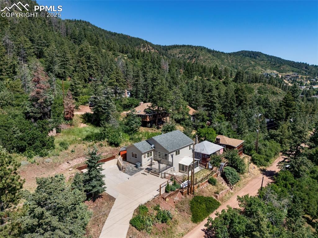 Custom-Built Home with Stunning Views & High-End Finishes in Palmer Lake’s Historic Glen.

Completely rebuilt from the ground up in 2008, this stunning custom home at the top of the Glen in Palmer Lake offers breathtaking views of Palmer Lake, Chautauqua, Elephant Rock, Limbaugh Canyon, and Ben Lomand. Thoughtfully designed with 2x6 construction, R38 insulation, Pella windows, and a 15kW two-stage electric forced air system with central A/C, this home delivers efficiency, comfort, and craftsmanship throughout.

Inside, you’ll find alder hardwood floors, solid knotty pine doors and trim, vaulted ceilings on the main level, and a gourmet kitchen featuring custom Brooks Brothers cabinetry, Cambria granite countertops, and a cast iron sink. The main-level bath includes heated floors, laundry hookups and an original cast iron clawfoot tub, blending old-world charm with modern convenience. All bedroom closets floors are cedar-lined.

The primary suite offers an attached 3/4 bathroom with slate tile and dual vanity. The finished walk-out basement features 9-ft ceilings, tile flooring, a restored 1800s wood-burning stove, and French doors leading to a cozy enclosed sunroom. A spacious en-suite bedroom setup is ready to go, complete with a 3/4 bath featuring a walk-in shower with dual heads, heated floors, and a vanity repurposed from an original 1920s Glen cabin dresser.

Additional features include a whole-house backup generator, storm windows, and flexible living spaces that easily accommodate a 3-bedroom layout.

Located minutes from Palmer Lake Reservoir, Glen Park, Limbaugh Canyon, Santa Fe Trail, and Greenland Open Space, this home is perfect for those who love hiking, paddle boarding, fishing, pickleball, and more. A true blend of character, quality, and Colorado lifestyle.