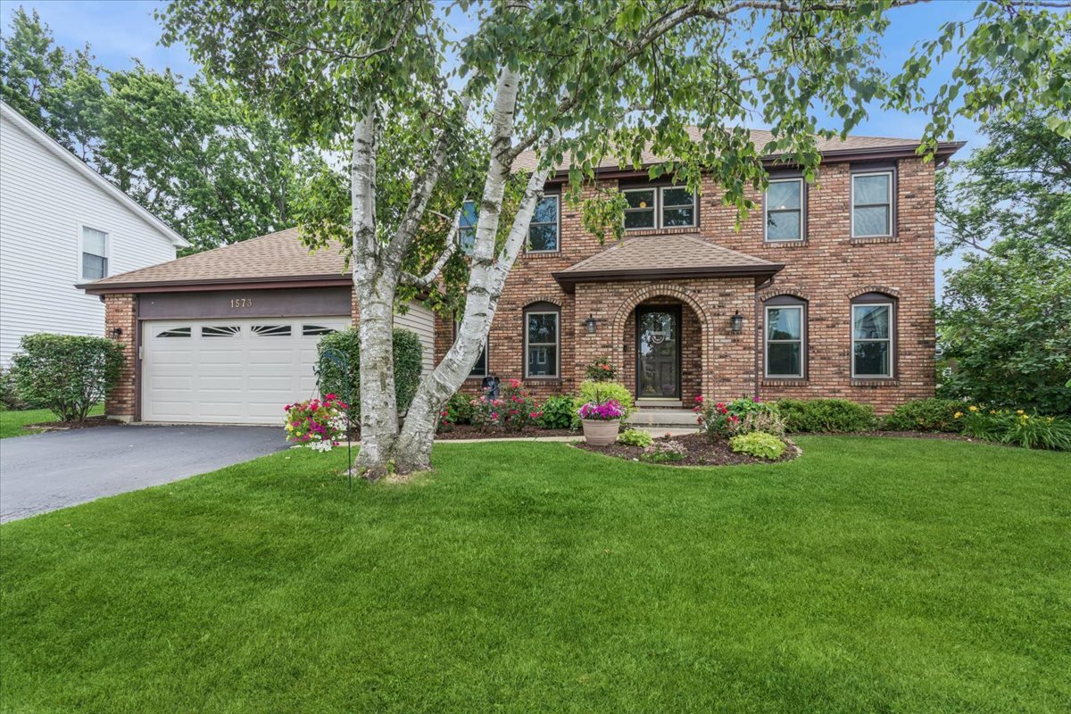 Welcome to this beautifully maintained, 5-bedroom, 2.5-bath classic! This beautiful home is tucked away on a quiet cul-de-sac with a spacious and lovingly landscaped yard. The main level is an entertainer's dream, anchored by a large eat-in kitchen that flows directly into a spacious family room. There you will find a built-in wet bar, a fireplace with a wood-burning stove insert, a large picture window overlooking the backyard, and beautiful ceiling beams. The 5th bedroom is being used as a dedicated office on the main level, but with the ample closet it offers flexibility as a guest room for visitors as well. Just down the path from one of District 203's renowned schools, Meadow Glens Elementary only adds to the ideal location of this home! Featuring bamboo flooring (installed in 2020) throughout most of the home and freshly painted (2026) in today's neutral tones, this home offers warmth, comfort, and true move-in ready appeal. The inviting floor plan provides generous space for both everyday living and entertaining. Upstairs, enjoy two updated bathrooms with custom tile work, and updated flooring. The primary suite features upgraded tray ceilings, generous space for a reading nook, and a large walk-in closet with built-in shelving. All bedrooms carry the updated bamboo flooring for a clean, fresh look throughout. The basement is ready for your creative vision and loaded with storage. Already in place are vinyl plank flooring and some carpet, a wet bar featuring a bar top from the iconic Chicago Tribune building, and a stainless steel bar sink & well from the Sardine Bar on Lakeshore Drive. Need a workshop? You'll find that here too, with ample space to store all of your tools. Enjoy peace of mind with major updates completed in recent years, including roof and siding, windows, garage door, furnace, wood flooring, and a concrete patio. Please see the Feature Sheet under "Additional Information" for a complete list. This is a wonderful opportunity to own a home where thoughtful updates blend seamlessly with classic charm. Welcome Home to 1573 Clemson Drive!