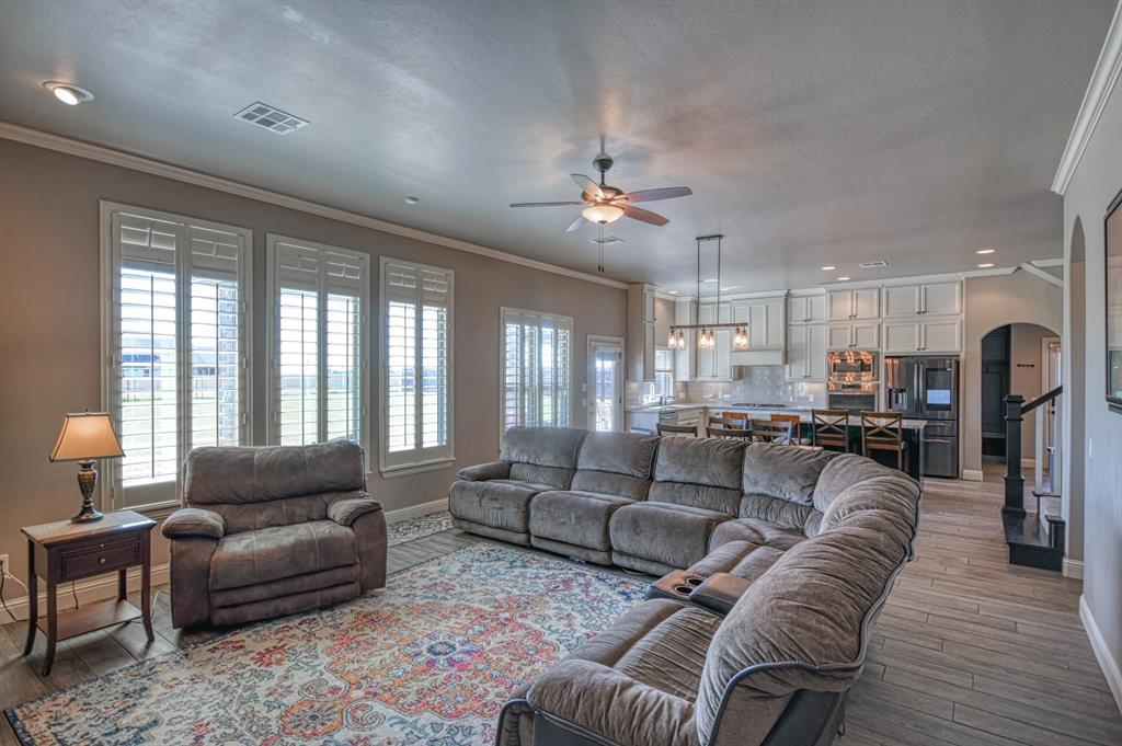 This one has it all!!! Elegance & functionality abound! Beautiful open living space with large island, including a breakfast bar AND a formal dining room. Plantation shutters add to the elegance. Kitchen is a chefs dream with loads of prep space and ample storage, including a pantry & large utility room w/ mud bench. Primary bedroom plus two secondary bedrooms are downstairs on the main floor with 2.1 baths. Owner's suite is huge with bay windows & large ensuite spa-like bathroom, including walk-in closet & separate garden tub and roll in shower. Upstairs is a large game/flex room AND 4th bedroom with full bath. Side-entry two car garage PLUS and added 3rd-car garage. Additional concrete pad & lovely wood pergola added to beautiful patio overlooking 1/2 acre & large fenced backyard. Landrun has a community pool & beckons you for a little taste of the country inside a friendly atmosphere. Easy access to I-35 & I-44 Turnpike.
