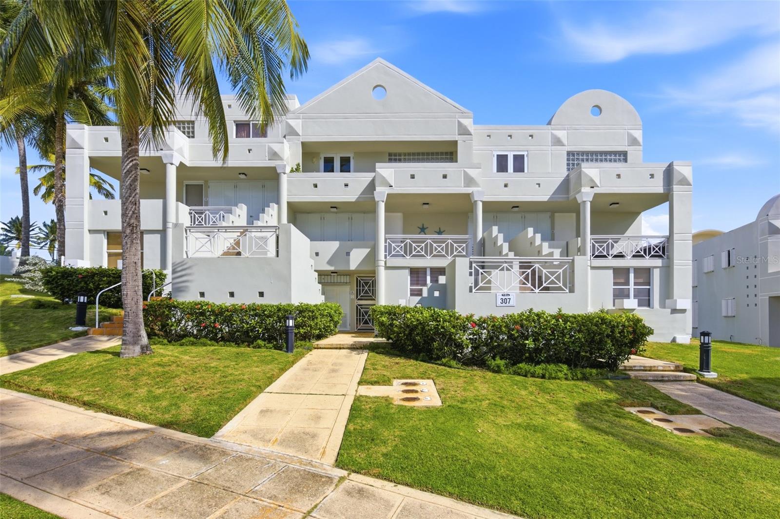 Fully renovated two-story villa located within a private cluster in the gated community of Costa Dorada in Dorado. This three-bedroom, three-bathroom residence is situated on the second level and offers direct views of the 10th hole of the golf course with an ocean backdrop. The interior features new flooring throughout, a renovated contemporary kitchen with updated cabinetry and finishes, and modernized bathrooms. The open-concept living and dining areas flow seamlessly onto a covered balcony overlooking the golf course, providing natural light, cross ventilation, and a strong indoor-outdoor connection. Residents enjoy gated security, private beach access within the complex, golf course facilities, tennis courts, fitness center, bowling alley, and on-site dining options. Golf-cart access connects you easily to the beach and surrounding amenities. The property includes two assigned parking spaces located directly in front of the cluster.