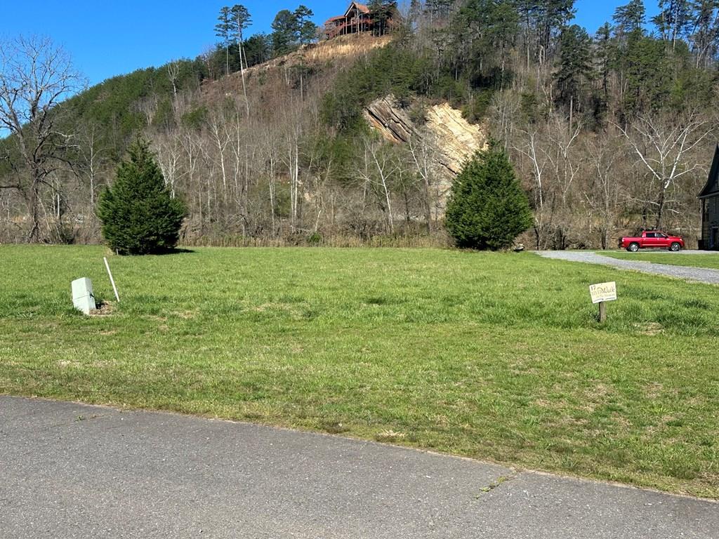 Wake up to the sound of the river on this beautiful 1.11-acre riverfront lot in Murphy, NC, located in the gated community of Riverwalk on the Hiwassee. This build-ready mountain property offers a rare opportunity to own Hiwassee River frontage with a 4-bedroom septic approval already in place, making it ideal for your dream home, vacation home, or investment property. Enjoy the benefits of underground utilities, a private and peaceful setting, and easy access just minutes to downtown Murphy, NC. Surrounded by the natural beauty of the North Carolina mountains, this property is perfect for those seeking mountain living, waterfront property, and outdoor recreation, including fishing, kayaking, and relaxing by the river. Whether you're looking to build a full-time residence, second home, or planning for the future, this Murphy NC riverfront property offers the perfect combination of location, usability, and lifestyle.