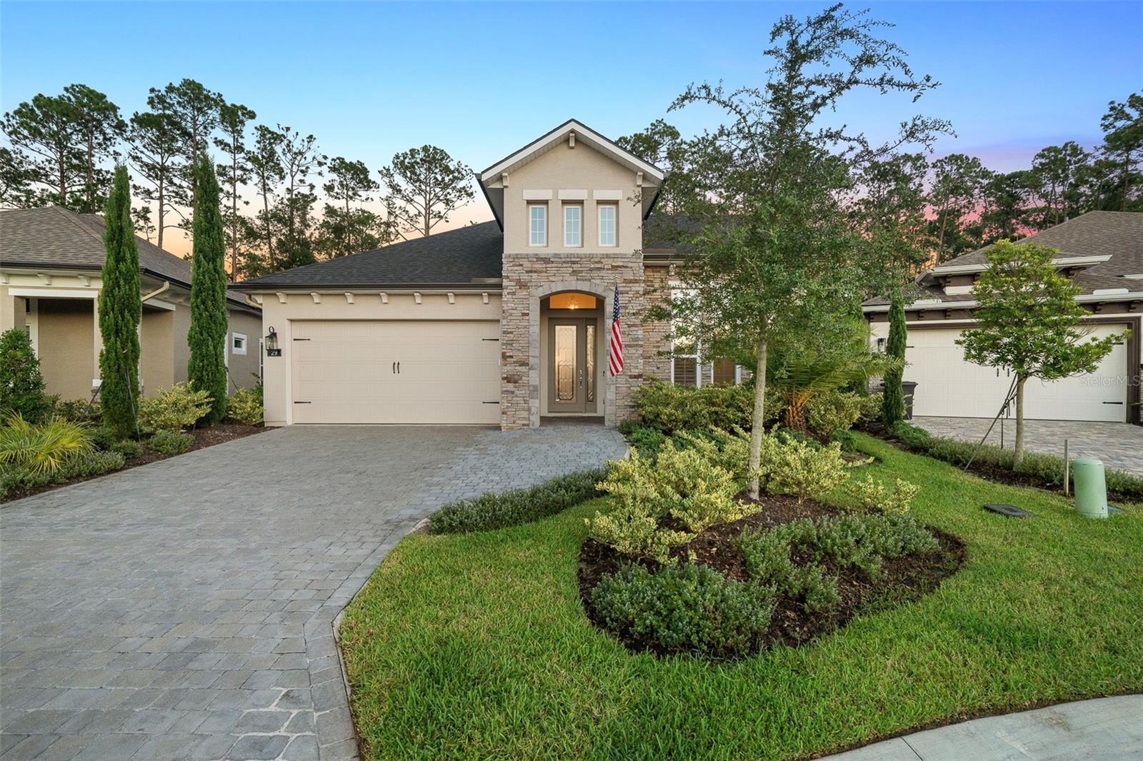 Under contract-accepting backup offers. Welcome to this beautifully maintained, serene setting, Serena II floor plan located in the sought-after, gated community of Plantation Bay Golf & Country Club. Offering three bedrooms plus an office, 2.5 baths, and 3 car garage, this home showcases stylish upgrades, high ceilings, and serene preserve views. Step through the glass-front double doors into a bright entryway featuring tile floors, tray ceilings, and designer finishes throughout. The open concept living area includes a family room with tray ceiling, tile floors, and four sliders that open seamlessly to the lanai—perfect for indoor-outdoor living. The kitchen is a true showpiece with 42-inch white cabinetry, quartz countertops with gold accents, built-in oven with air fryer feature and microwave, pantry with wood shelving, and a large island with pendant lighting. The dining area is equally elegant, surrounded by natural light and ideal for entertaining accented with the continuous tile flooring. The primary suite features tray ceilings, preserve views, and a luxurious spa-style bath with dual quartz vanities, walk-in shower, private water closet with wood cabinetry, and an expansive walk-in closet. Bedrooms two and three offer plush carpet, plantation shutters, and generous closet space, while the 2nd bath impresses with tile to the ceiling and quartz finishes. Additional guest bath perfect hosting. Flex room/Office is great for whatever you may need with double doors, tile floors, and plantation shutters. Enjoy Florida living at its finest on the covered, extended lanai complete with pavers, outdoor counter with fridge, granite countertop, and remote shade, surrounded by a screened enclosure with mega screen feature, extended green space area, and lush preserve views. The property offers complete privacy, anchored at end of cul-de-sac on a private street. This 2024 built home has additional highlights including epoxy-coated garage floors, whole house water-filtration system, electric roll-down screens on, additional exterior soffit light, gutter system, widened pavers driveway, and a hybrid hot-water system. The home has been meticulously cared and elegantly completed. Located in Plantation Bay, one of Ormond Beach's premier gated golf communities, residents enjoy optional club memberships with 45 holes of golf, 9 tennis courts, 10 pickle ball courts, fitness/spa center, resort-style pools, new 30 million dollar Founder Clubhouse, additional Prestwick Clubhouse & cabana bar and grill, and full events calendar. Buyers of this home to receive a substantial discount on initiation fee at the club. Ask listing agent for details. Enjoy the perfect blend of luxury, privacy, and convenience in this stunning Serena II home-where modern design meets the best of the Plantation Bay lifestyle.