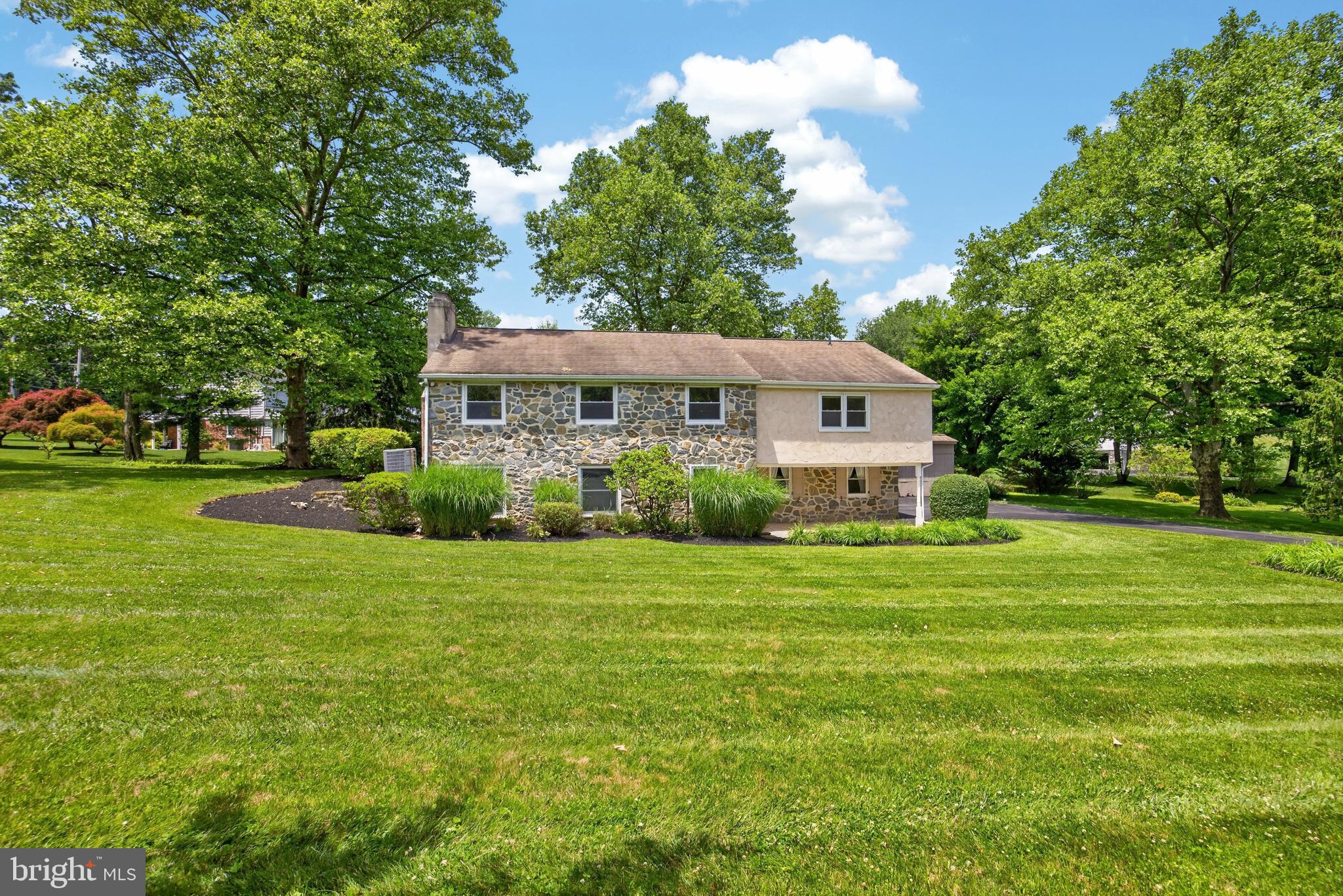 Welcome to 1190 Beaumont Road, a beautifully maintained raised ranch home set on a picturesque 1.4-acre lot in the award-winning Tredyffrin-Easttown School District. Freshly painted and thoughtfully landscaped, this 4-bedroom, 2.5-bath residence offers over 2,900 square feet of finished living space, blending comfort, functionality, and timeless appeal in a sought-after Berwyn location.Upon entering the home, you're welcomed by a spacious foyer/mudroom area that provides convenient access to a powder room and the lower-level living space. This inviting family room features a striking stone wall and fireplace, creating a warm and cozy atmosphere perfect for relaxing or entertaining. The lower level also offers a generous storage area with direct access to the attached two-car garage.Upstairs, natural light fills the main living spaces. The living room, complete with a fireplace, flows seamlessly into the dining room, creating an ideal layout for everyday living and gatherings alike. The kitchen is both stylish and functional, featuring quartz countertops, ample cabinetry, a skylight, and direct access to the deck-perfect for enjoying morning coffee or dining outdoors while overlooking the expansive property.The main level is home to four spacious bedrooms, including a primary suite with a private ensuite bath. Hardwood floors extend throughout most of the level, adding warmth and character to the home's inviting interior.Outside, the 1.4-acre lot provides an exceptional setting with plenty of room to play, garden, entertain, or simply enjoy the beauty of the surrounding landscape. A detached shed offers additional storage for tools, equipment, or hobby space.Ideally located near major commuter routes, shopping, dining, parks, and all that the Main Line has to offer, 1190 Beaumont Road presents a rare opportunity to enjoy space, privacy, and convenience in one of the region's most desirable communities.