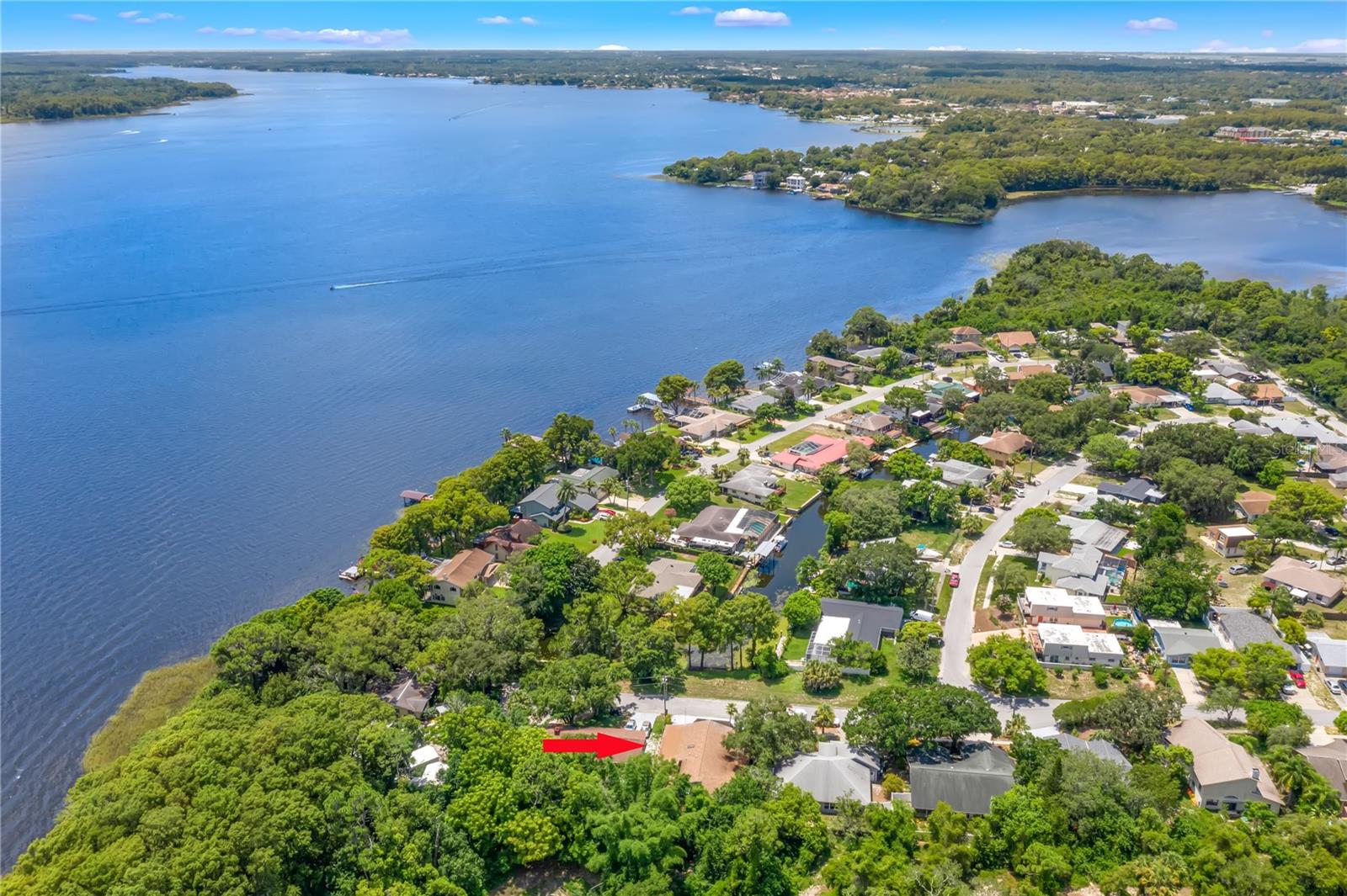 Canal-front Lake Tarpon home featuring 4 bedrooms, 2 bathrooms and a private rear setting backing to Highland Nature Park Preserve. Located on a quiet cul-de-sac, this light-filled home offers Lake Tarpon views from the oversized great room, an open kitchen with stainless-steel appliances and skylight, a spacious primary suite with walk-in closet, two laundry rooms, updated bathrooms, waterproof laminate flooring and generously sized bedrooms.Enjoy the rear patio and brand-new deck overlooking the preserve, mature trees and peaceful backyard. A private gate provides access to the preserve, fishing pier and Lake Tarpon. Additional features include an air-conditioned workshop with plumbing, two tandem driveways, parking for approximately seven vehicles or small watercraft, outdoor shower and large attic. Recent updates include the roof, HVAC, plumbing, exterior paint, gutters, lighting, and fans. Conveniently located near the Sponge Docks, restaurants, schools, airports and beaches.