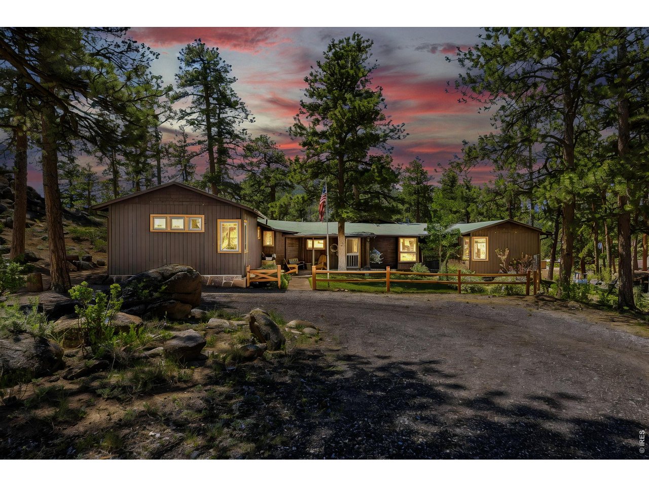 Longs Peak and Meeker Mountain greet you first. The quiet comes second. This is just over an acre in High Drive Heights, one of the oldest and most iconic neighborhoods in Estes Park.The home began as a 1926 cabin and grew the way the best mountain homes do, one thoughtful addition at a time, each built to match the last. Wood floors and vaulted tongue-and-groove ceilings run through the living and dining rooms, where a gas stove identical to the wood-burning Vermont Castings model it replaced sits on the brick hearth. The sunroom holds the light all day, with a wet bar, a tile floor, and woodwork matched to the rest of the house, and it tends to become the room people use most. Antique doors saved from the Stanley Hotel open into a fourth bedroom that doubles as a study, its Murphy bed folding away for overnight guests or a quiet day of work.Across four bedrooms and three baths are the kind of details that only show up in homes built by hand: built-in window seats with storage tucked underneath, and heated floors in two of the baths that take the edge off a January morning. Outside, a three-car garage with 12-foot bays gives the trucks and the gear room to spread out.Out back, a private brick patio sits at the corner of the lot, beside rock formations and ponderosa pines that are part of the property, some of those pines older than the cabin itself. It is the kind of spot where you take your coffee and watch the morning come up over the rocks.Deer move through. In spring, the elk calve right here on the hillside. It is private, it is quiet, and it feels a long way from anywhere.Downtown sits 2.1 miles away, and the entrance to Rocky Mountain National Park is 2.7, reached without driving through town. Close to everything, a world away from the crowds. This is an older home with real history and real character, on a piece of Estes Park that is gettingharder to find. Come see it in person, and let the place make its own case.