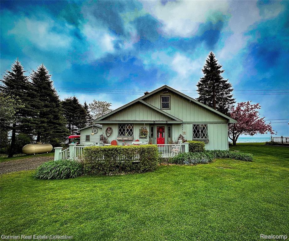 Stunning on Lake Huron! Tucked off of historic M-25, is a fully renovated 3 bedroom, 1 & 1/2 bath waterfront home. Watch the beautiful sunrises on the well maintained deck or screened in porch in the summer months, and enjoy the sunrises through the many windows on the back of the home looking to the lake, as you're cozied up next to the wood burning stove fireplace. Home is open and airy from the living room, dining room, and kitchen. Primary bedroom and second bedroom is located on the main floor, with a large full bath adjacent, and a half bath located towards the front of the home. Heading upstairs is a welcoming loft, with panoramic views of the lower level, and perfect spot to watch the freighters. Off of the loft, is the very large third bedroom, that will hold guests comfortably. Walk the well groomed property and you will see many fruit trees such as apples, pears, cherry, and peaches. The landscape/garden area is very loved and maintained, and the beach has the perfect spot for evening gatherings around the campfire. Close to the beach is the "Bunkie" where beach/water equipment and patio furniture can be stored, and to the side is a custom kayak holder. The garage is located in the front of the property, and is spotless. This truly is a must see property. Call today to schedule your showing.