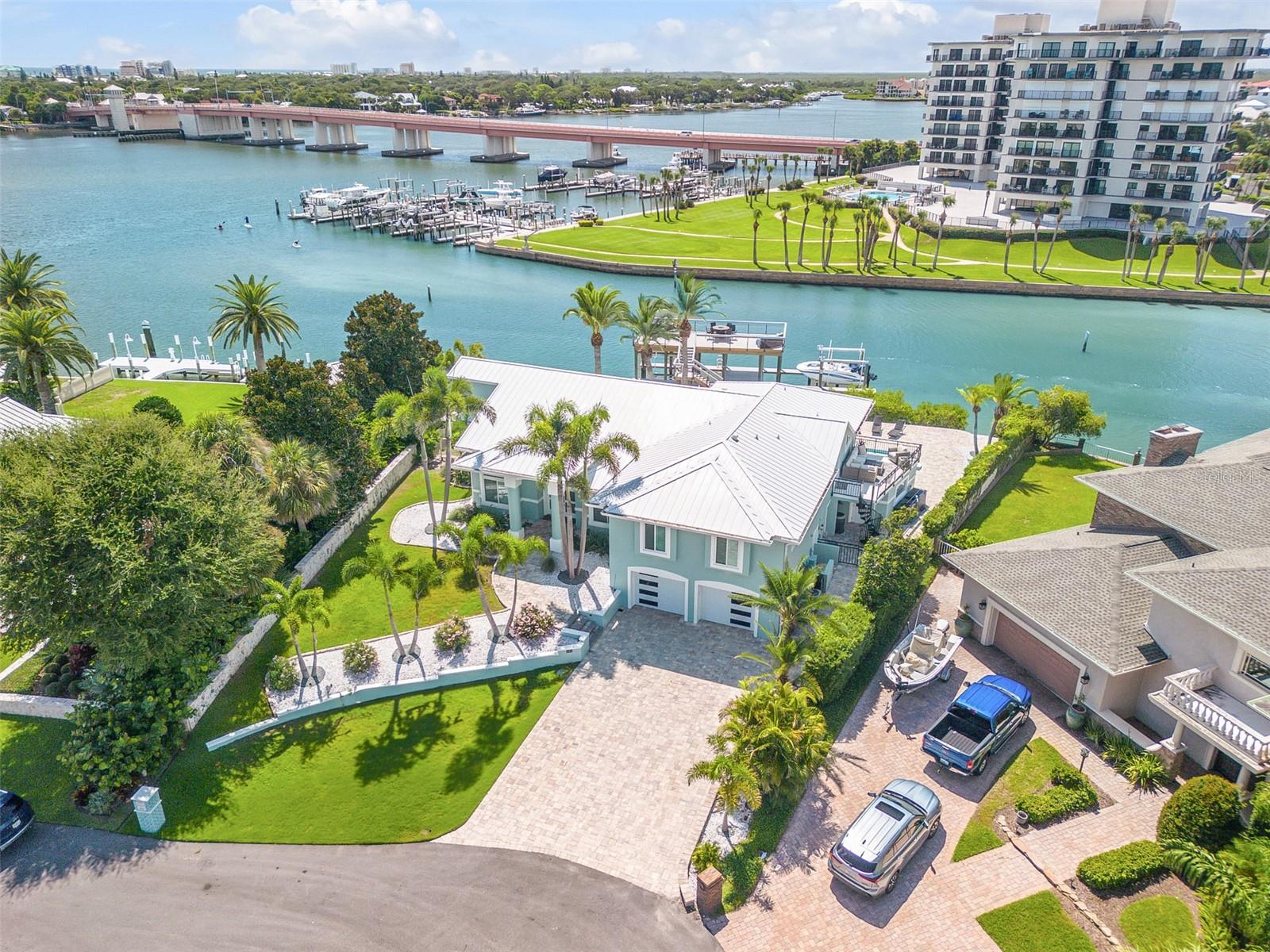 All offers are welcome. Seller is motivated and will thoughtfully consider all offers presented. Direct Intracoastal beachside deep water 6Bd, 4 ½ Ba, 2 Car Garage Island home. Exquisitely renovated year 2024. Offered fully furnished. One of the closest homes to the New Smyrna Beach Inlet, this waterfront property allows a quick offshore access without passing under a bridge. One bedroom on the lower level could function as a private in-law suite with its own entrance, full bath and laundry area. All countertops in the home including kitchen, bars, bathrooms and laundry room feature matching quartz. There are wrap around floor to ceiling windows in living room and kitchen and hardwood flooring throughout. The updated chef’s kitchen has two islands, stainless appliances and oversize custom wood cabinets. Custom cabinets are also featured in the laundry room and bedroom closets with 8’ doors throughout the home. The gas fireplace in living room adds to the overall ambiance. High Impact windows, 2 A/C units, no-slip floors in garage are all upgraded extras. Plantation shutters are on all windows. The primary en-suite has a free-standing tub and a huge walk-in shower with two rain shower head and its own laundry room. A circular stairway from the primary suite leads down to a private balcony for relaxing while watching the tranquil waterways. Paver walkways are throughout the property. The pool is equipped with a fountain, lighting features and sun shelf. The custom-built dock includes two boat lifts—a 13,000-lb covered lift and a 16,000-lb lift, both equipped with water and electric. An upper-level entertaining and viewing deck above the boat house has water, electric, furniture, and bar creating the perfect space for hosting many guests for a quiet evening on the water