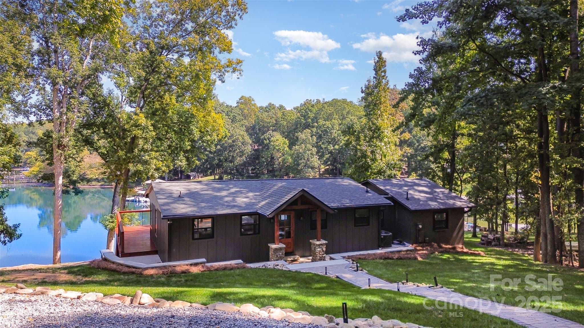 Lake Norman Luxury Retreat – A Private Cove Masterpiece with Airbnb Potential!

Welcome to the ultimate Lake Norman escape, where timeless sophistication meets modern convenience in one of Mooresville’s most sought-after waterfront locations. Perfectly tucked away on a peaceful private cove off Brawley School Road, this fully furnished 3-bedroom, 3-bathroom estate has been reimagined from the studs up by its discerning builder-owner. Every detail was curated to deliver an extraordinary lakefront lifestyle—whether as a private sanctuary, an exclusive investment, or both.

Inside, an open, airy floor plan invites seamless living and entertaining. The chef’s kitchen flows effortlessly into the dining and living spaces, where expansive windows frame tranquil water views. The main deck is a showpiece for sunrise coffees and sunset toasts, while the covered patio below ensures year-round enjoyment. A finished walkout basement with a private entrance adds versatility, perfect for a guest suite, in-law retreat, or entertainment lounge.

Outdoors, the experience reaches new heights. Enjoy summer afternoons on your brand-new covered dock, gather around the firepit under the stars, or explore the calm waters of your secluded cove. A private drive with a wraparound driveway enhances exclusivity and ease.

This 2,164 sq. ft. retreat comfortably sleeps eight and is offered fully furnished—including lake toys—making it turnkey for immediate enjoyment or a proven Airbnb income opportunity.

With its rare combination of seclusion, elegance, and investment potential, this Lake Norman retreat is more than a home—it’s a lifestyle defined by luxury, leisure, and limitless possibility. Schedule your private tour today!