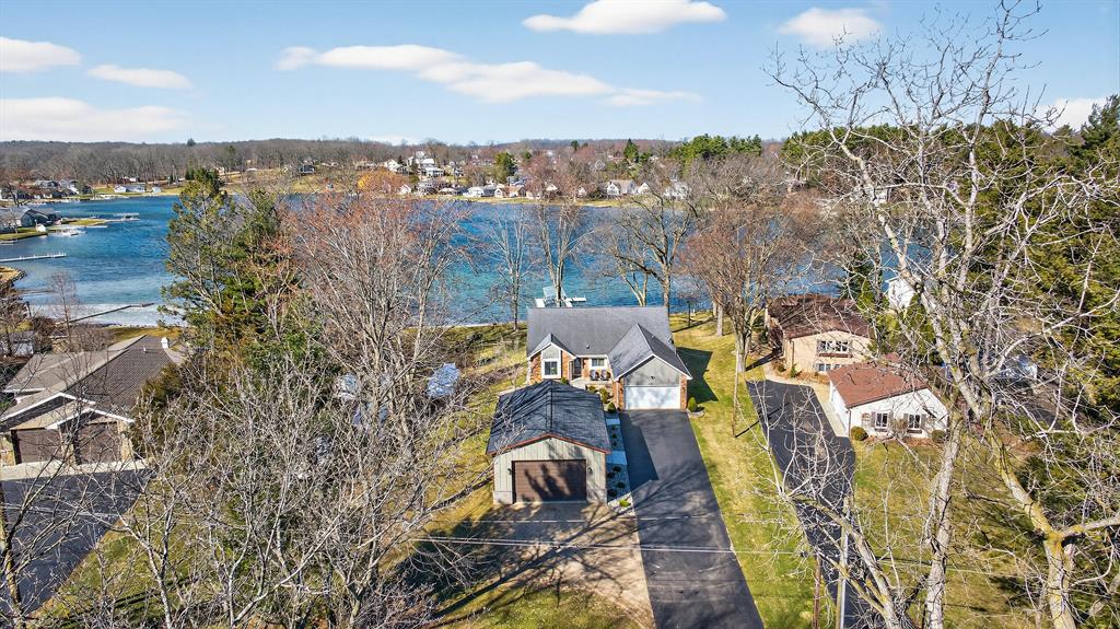 LAKEFRONT LUXURY! THIS HOME HAS ALL OF THE BELLS & WHISTLES YOU DREAM OF PLUS A BRAND NEW POLE BARN! This premier setting on Southern Michigan's most desired clean & clear, spring-fed chain-of-lakes features 100 feet of lake frontage. Enjoy swimming, fishing & exploring as you sink your toes into these SANDY SHORES sprawling across the LEVEL LOT right to the waters edge! THIS is the ULTIMATE lake home! Contemporary design with top-notch quality, finishes & sweeping panoramic views! Soaring ceilings & walls of windows envisioned around the art of entertaining. Gourmet kitchen-island w/seating, all the cabinets & counters you could dream of. Main floor living & custom primary suite-WIC, tiled shower/floors & dual vanities. Cozy up with your morning coffee or evening refresher in your privately enclosed 3 seasons room right off the primary ensuite. Striking wood floors with updated bathrooms and kitchen make this home easy to love & move-in ready so you can start your Summer season now!The owners have thought of everything you'll want for low-maintenance from the fresh paint to the new concrete sidewalks, landscaping, composite decking to the metal & stone sided barn. Modern flat ceilings and partially finished basement offer a great space for family & friends, game rooms & sleepovers! The entertaining space carries to the beautiful brick exterior, composite decks, the most desirable enclosed porches to the covered patio & right along the shore. The lengthy paved driveway will easily ensure parking for everyone & the new 32x24 barn (built-in 2025) is a perfect place for boat & toy storage with12 foot walls, a 16x10 overhead door, an additional 8x10 door, concrete floors & electric. The vaulted overhang features tongue & groove ceilings with recessed lighting and a comfortable patio to soak in the hot tub while overlooking the water. Newer water softener. New iron filter (2024). A beautiful, maintenance-free 4 foot wide docking system with electronic boat lift is included complete with a set of stairs into the beach.