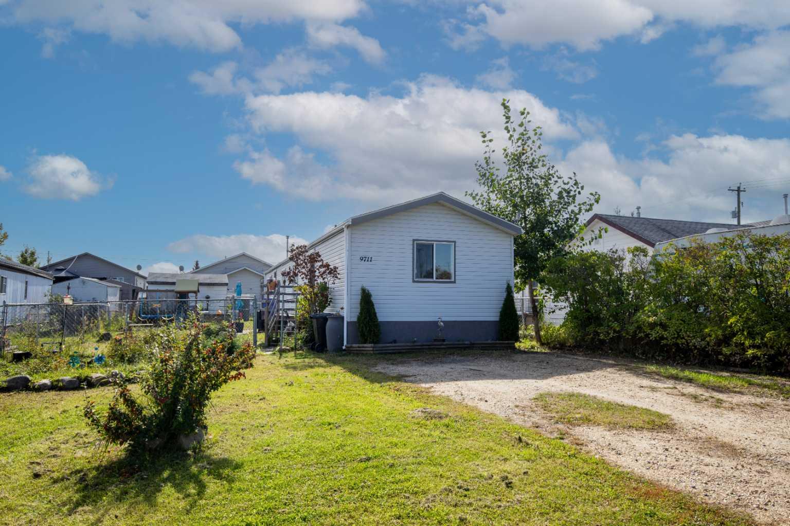Affordable home in Clairmont with QUICK POSSESSION available. This is a 16' x 76' manufactured home is on its own large 50' x 120' lot.  Features 3 bedrooms, two full bathrooms with jetted tubs, some new light fixtures, tile backsplash in kitchen, vaulted ceilings, newer flooring throughout most of the home, recently painted, skirting was redone, and has new shingles.  Also has newer fridge, stove and dishwasher.  Outside offers a large fenced lot, large parking pad, and two sheds for storage.