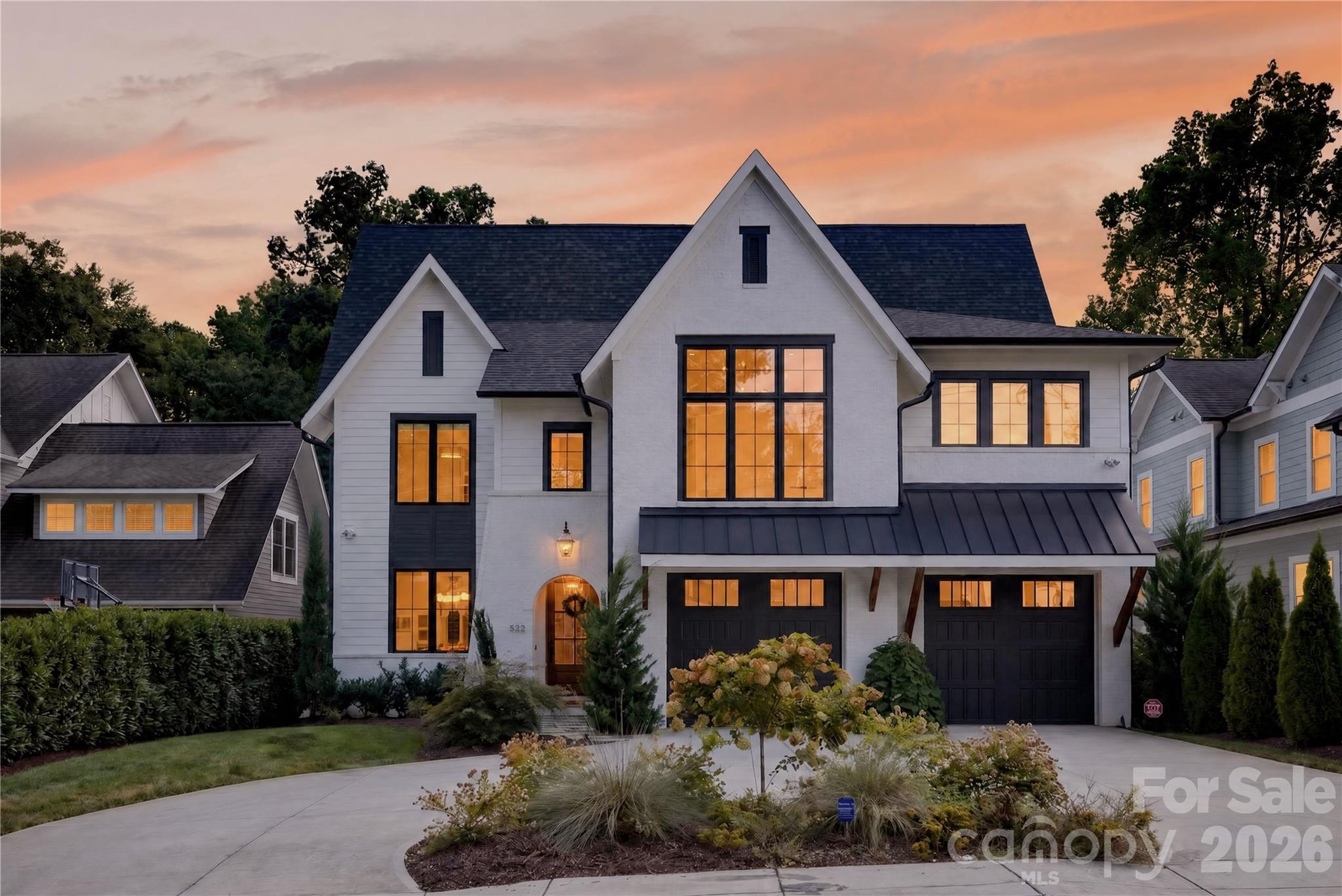 This 5,807 square foot luxury transitional home offers six bedrooms and six bathrooms in Charlotte’s charming Dilworth neighborhood. Built in 2023, the home is centrally located a short walk from the light rail and the dining, shopping and entertainment of South End. The open floor plan has designer finishes and white oak hardwoods throughout. The chef’s kitchen features an oversized island, JennAir range, 66-inch refrigeration, quartz countertops and a spacious scullery equipped with a sink, ice maker and beverage refrigerator. Wood ceiling beams and a cast stone fireplace surround create a warm focal point in the family room. The primary suite includes a vaulted ceiling, a private den or study connected by a hidden door, a spa inspired bathroom featuring a walk in shower, freestanding soaking tub by an electric fireplace and an expansive walk in closet with an island. Each additional bedroom includes an ensuite bathroom. The home has a large bonus room connected to a dedicated bar area. Designed for indoor outdoor living, the covered porch offers a fireplace and built in kitchen with a grill, sink, refrigerator and exhaust hood. Beyond it is a large, fenced and private backyard with irrigation. A gate in the rear fence provides direct access to Sedgefield Park that includes walking trails and additional amenities. The home has 2 car garage and a circular driveway.