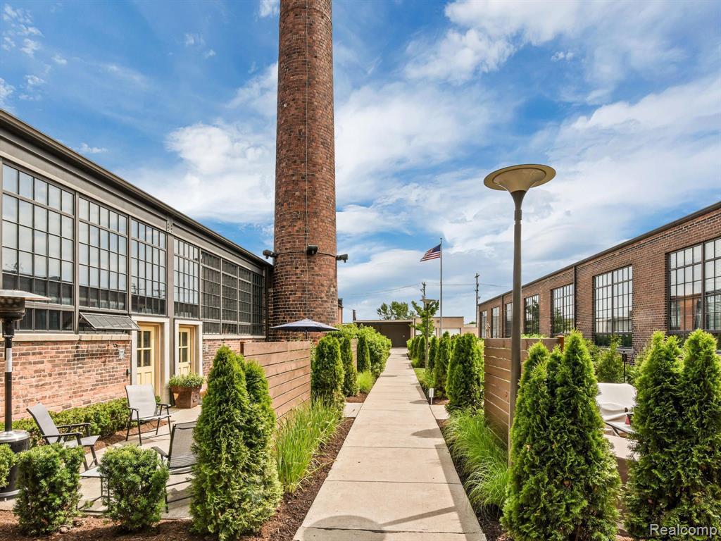 This might just be the most beautiful loft in Detroit.
And it’s ready for you to fall in love.

Unit 107 at the FD Lofts is a bold and beautifully executed renovation inside a historic former Detroit Fire Department station. With its soaring ceilings, polished concrete floors, and exposed brick and ductwork, the space stays true to its industrial roots—while introducing refined, contemporary finishes throughout.

The kitchen is a standout: dramatic marble countertops, sleek white cabinetry, and premium KitchenAid appliances, all designed to anchor the open-plan layout and invite entertaining. The living room is framed by towering windows and original brickwork, offering both volume and warmth.

Upstairs, the lofted primary suite offers privacy and comfort, while a second mezzanine space adds versatility—perfect for a home office, guest room, or creative studio. The bathrooms are clean and modern, finished in matte black fixtures and elegant stone surfaces.

Located at the edge of Eastern Market, the FD Lofts place you in the center of one of Detroit’s most vibrant, walkable neighborhoods. You’re just steps from weekend produce hauls, flower stands, and some of the city’s best cafes, boutiques, outdoor art—and only a short stroll to downtown, stadiums, and the Dequindre Cut trail.

Authentic loft living. Thoughtfully reimagined.
