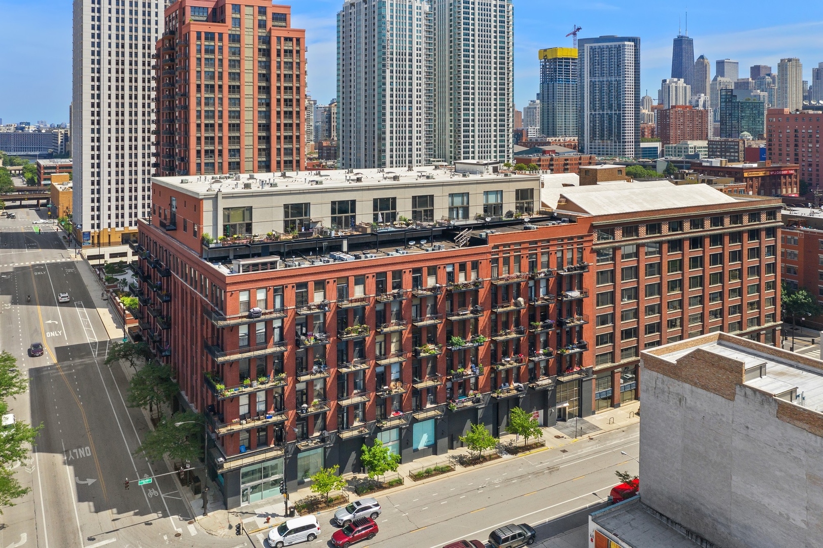 Come see this just-renovated north-facing penthouse duplex in the heart of the popular Fulton Market River District, a niche neighborhood within the West Loop. Unit 703 has been painted throughout, and features 18-foot ceilings, a wall of windows capturing the skyline, diagonal hardwood floors, a 10-20 terrace with Trex decking located off the living room, in-unit washer and dryer, fireplace, and a 10-15 storage cage. The kitchen was renovated in 2022 and features new cabinets, quartz countertops, and a Miele refrigerator, stove/oven, dishwasher, and finishes off with a Dacor microwave. Upstairs, the main bedroom serves as a sanctuary, with a walk-in organized closet, a skylight, and a luxurious marble master bathroom featuring dual vanity sinks.  The second bedroom is now enclosed with an ensuite bathroom. Noteworthy features include a newer 2018 HVAC system and water heater. This property epitomizes a sophisticated urban lifestyle, steps away from the award-winning restaurant Row, the river walk, the Loop, and the renowned East Bank Club. Take advantage of this unparalleled opportunity to make your home in one of Chicago's most sought-after neighborhoods. A deeded garage parking is available for an additional $30K.
