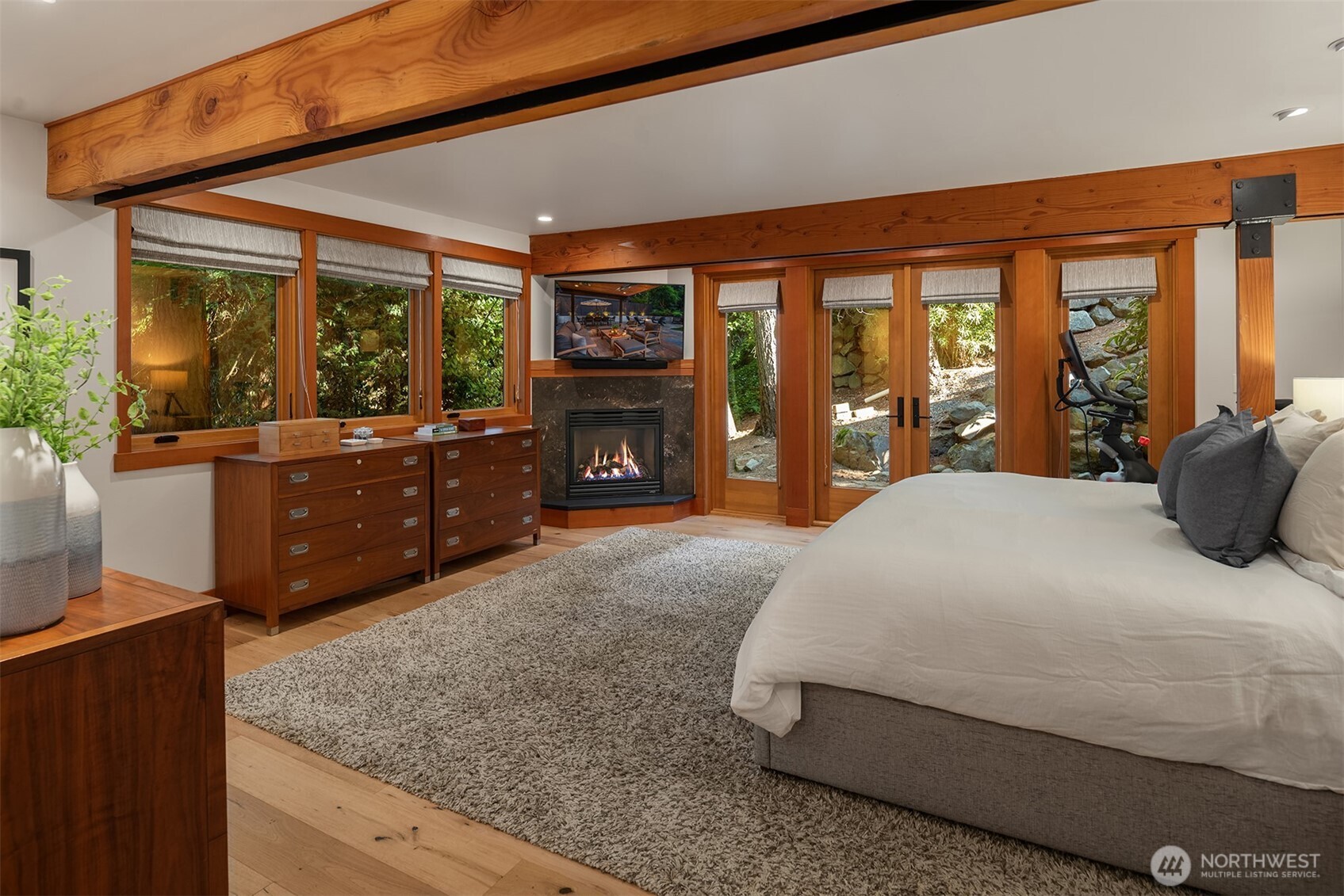 Primary bedroom with fireplace and private patio access