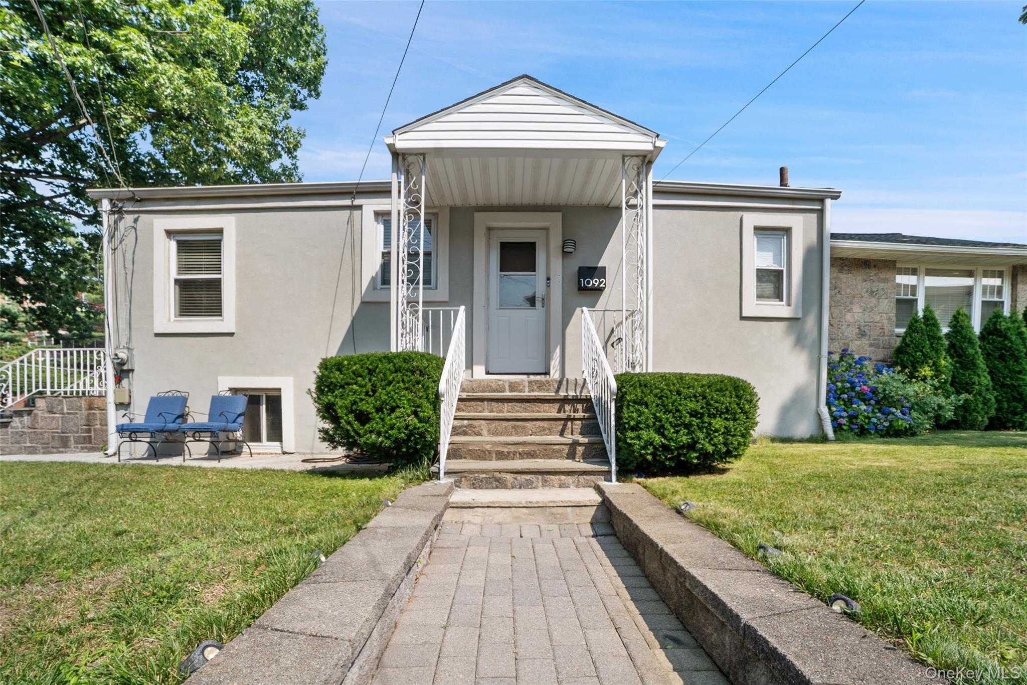 This move-in-ready home combines comfort, convenience, and value in a highly sought-after Bronxville P.O. neighborhood with lower Yonkers taxes. This well located beautiful  Ranch House features three (3) well-sized bedrooms, spacious living room that is ideal for large family gatherings, and a comfortable deck and backyard for relaxing or entertaining. It also offers the rare convenience of single-level living. The features you will love include: New Roof installed November 2023 (still with several years Warrantee); Updated kitchen with modern finishes and stainless steel appliances; 2 fully updated bathrooms with self-lifting lead; Expansive driveway with parking for up to 6 vehicles; In-ground sprinkler system for easy maintenance; Fully finished basement with laundry, storage, and bonus room. Prime Location, with easy access/walk to Metro-North for a direct NYC commute. This house is approximately five (5) minutes walk to Cross County Center and eight (8) minutes drive to Ridge Hill Shopping Center. Convenient to I-87, Cross County Parkway, Bronx River Parkway and Saw Mill River Parkway. This house location is approximately 20-25 minutes drive to Westchester County Airport.Set on a quiet tree-lined residential corner street property, this home offers a calm suburban feel while keeping you close to everything, shopping, dining, and travel are all remarkably convenient . This is a true turnkey property ready for it's next owner. Just pack your bags and move right in. This is a large corner property  AKA 1092 Midland Ave at the junction with McGeory Street. with zip code 10708. Enjoy the low property taxes.