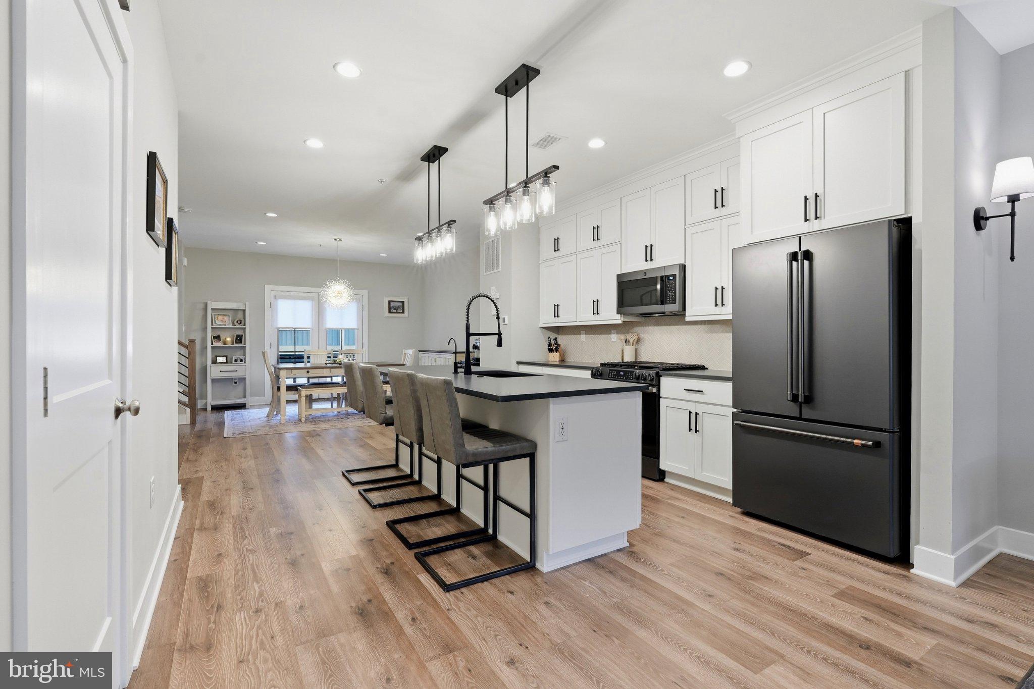 Welcome to 336 Walnut Street, a beautifully appointed 3-bedroom, 2.5-bath upscale townhome built by W.B. Homes in 2022, offering contemporary finishes, flexible living space and an exceptional location within the Perkiomen Valley School District.The entry level features a versatile flex room, ideal for a home office, fitness room, media space or additional living area. An attached two-car garage with an upgraded epoxy-coated floor provides convenient parking and storage.Upstairs, the heart of the home is a bright and spacious open-concept main level seamlessly connecting the kitchen, dining and living areas. The impressive kitchen is anchored by a massive center island with quartz countertops, generous seating and a built-in BLANCO sink with pull-down faucet. Crisp white cabinetry, additional built-in cabinetry, sleek black hardware and a beautiful herringbone tile backsplash create a sophisticated contemporary look. The appliance package features matte black steel refrigerator, natural gas range and microwave, along with a stainless steel dishwasher. A reverse-osmosis water filtration system adds another thoughtful upgrade.The adjoining living area is highlighted by an electric fireplace, creating an inviting focal point for relaxing or entertaining. Step outside onto the elevated composite deck with retractable awning, providing an ideal extension of the living space for outdoor dining, entertaining or simply unwinding.Upstairs, the spacious primary suite offers a private retreat featuring a tray ceiling, walk-in closet and en-suite bath with dual-sink vanity and glass-enclosed shower. Two additional bedrooms provide flexibility for family, guests or office space, while the conveniently located upper-level laundry room makes everyday living easier.Additional features include stylish architectural details throughout, central air conditioning and natural gas forced-air heat.The location is equally impressive. Situated within a stone's throw of the Ursinus College campus and Collegeville Community Park, the home also offers convenient access to the Perkiomen Trail for walking, running and biking. Shopping, dining and entertainment are nearby at Providence Town Center, while easy access to Route 422 provides a convenient connection to King of Prussia and its extensive shopping, restaurants, entertainment and employment centers.With 2022 construction, sophisticated finishes, an exceptional kitchen, flexible living space, outdoor entertaining area and two-car garage, 336 Walnut Street offers an outstanding opportunity to enjoy a modern, low-maintenance lifestyle in the heart of Collegeville. **Seller offering a Seller Assist towards a 2/1 Rate Buydown **